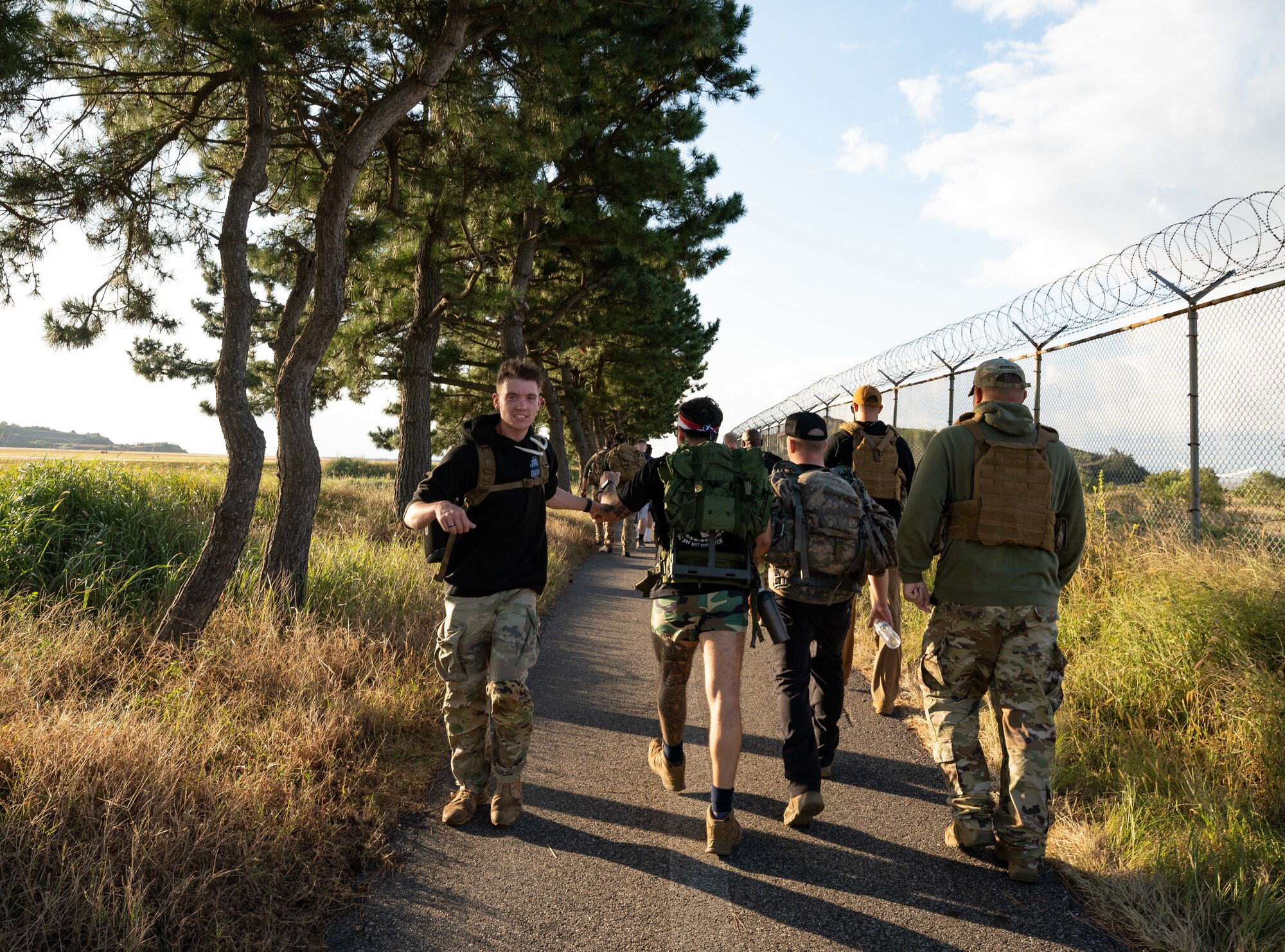 An Airman elbow bumps his Wingmen during a Prisoner of War and Missing in Action ruck event at Kunsan Air Base, Republic of Korea, Oct. 7, 2022. More than 100 servicemembers ran or rucked approximately six miles during the event, paying tribute to POW/MIA members who are currently missing and those whose remains haven’t been found dating all the way back to World War II. (U.S. Air Force photo by Staff Sgt. Sadie Colbert)