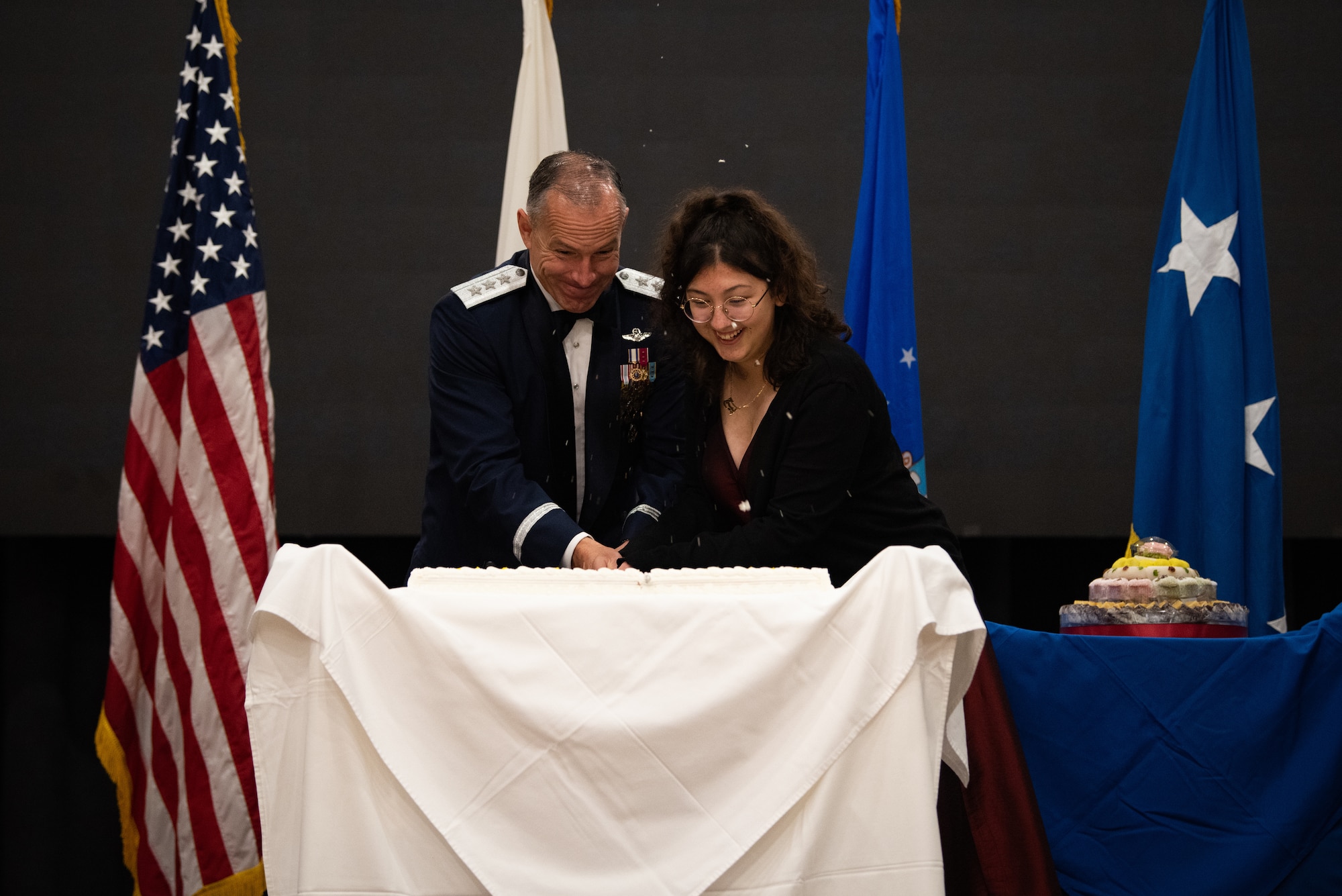 U.S. Air Force Lt. Gen. Scott Pleus, 7th Air Force commander, and Airman 1st Class Kiyoko Getjets, 51st Force Support Squadron force management technician, cut a birthday cake during the 75th Air Force Ball at Osan Air Base, Republic of Korea, Oct. 15th, 2022.