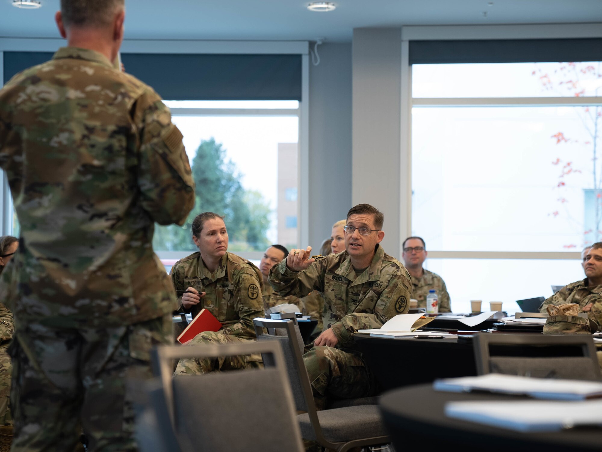 Col. James Watts talks with Col. Michael Fea.