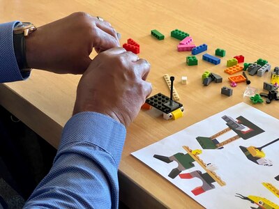 man builds with blocks on a table