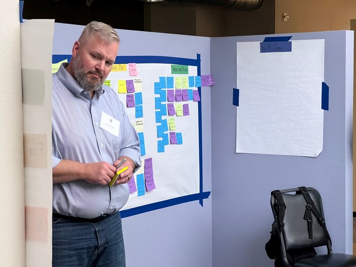 man holds paper looking at presentation