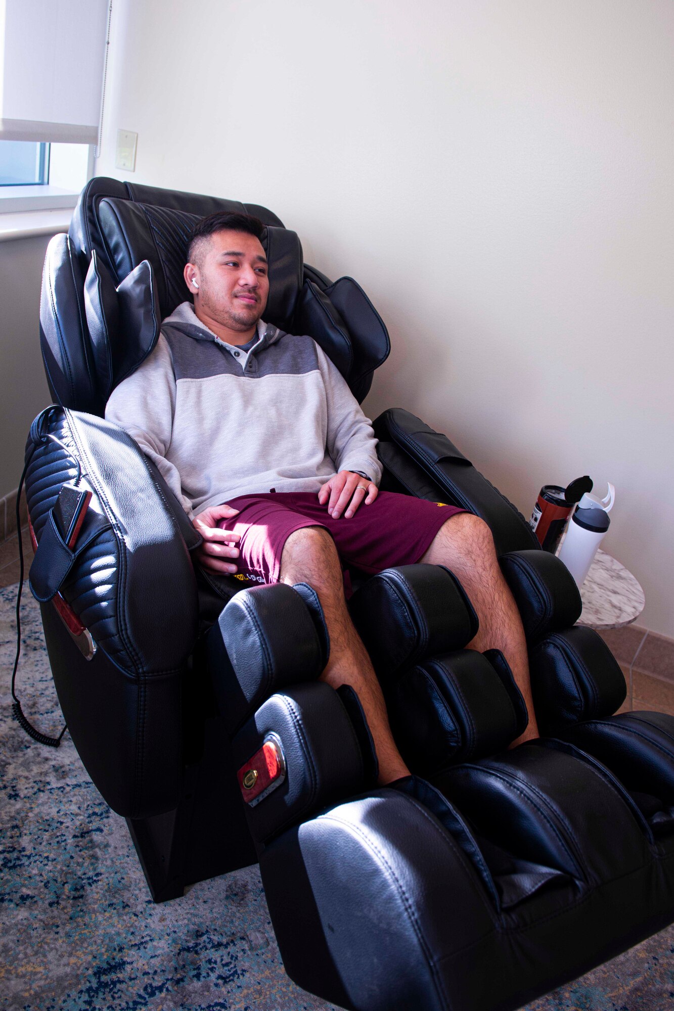 Tim Nguyen, 934 AW Bioenvironmental Engineering Flight industrial hygienist, uses a massage chair during a work break at the new wellness center at the Minneapolis-St. Paul Air Reserve Station, Minnesota on Oct. 5, 2022. (U.S. Air Force photo by Chris Farley) The wellness center is for base personnel to use for de-stressing from work tension or for simply relaxing in a comfortable environment.