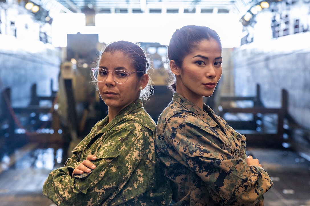U.S. Marine Corps Lance Cpl. Charisse Briguera, right, a rifle Marine with Delta Company, 4th Light Armored Reconnaissance Battalion, 4th Marine Division, in support of Special Purpose Marine Air-Ground Task Force UNITAS LXIII poses for a photo with Marina Milagros Correa (Private Uruguayan Marine Corps) during exercise UNITAS LXIII aboard the amphibious transport dock ship USS Mesa Verde (LPD 19), Sept. 10, 2022. UNITAS trains forces to conduct joint maritime operations through the execution of anti-surface, anti-submarine, anti-air, amphibious, and electronic warfare operations that enhance warfighting proficiency and increase interoperability among participating navy and marine forces. (U.S. Marine Corps photo by Lance Cpl. David Intriago)