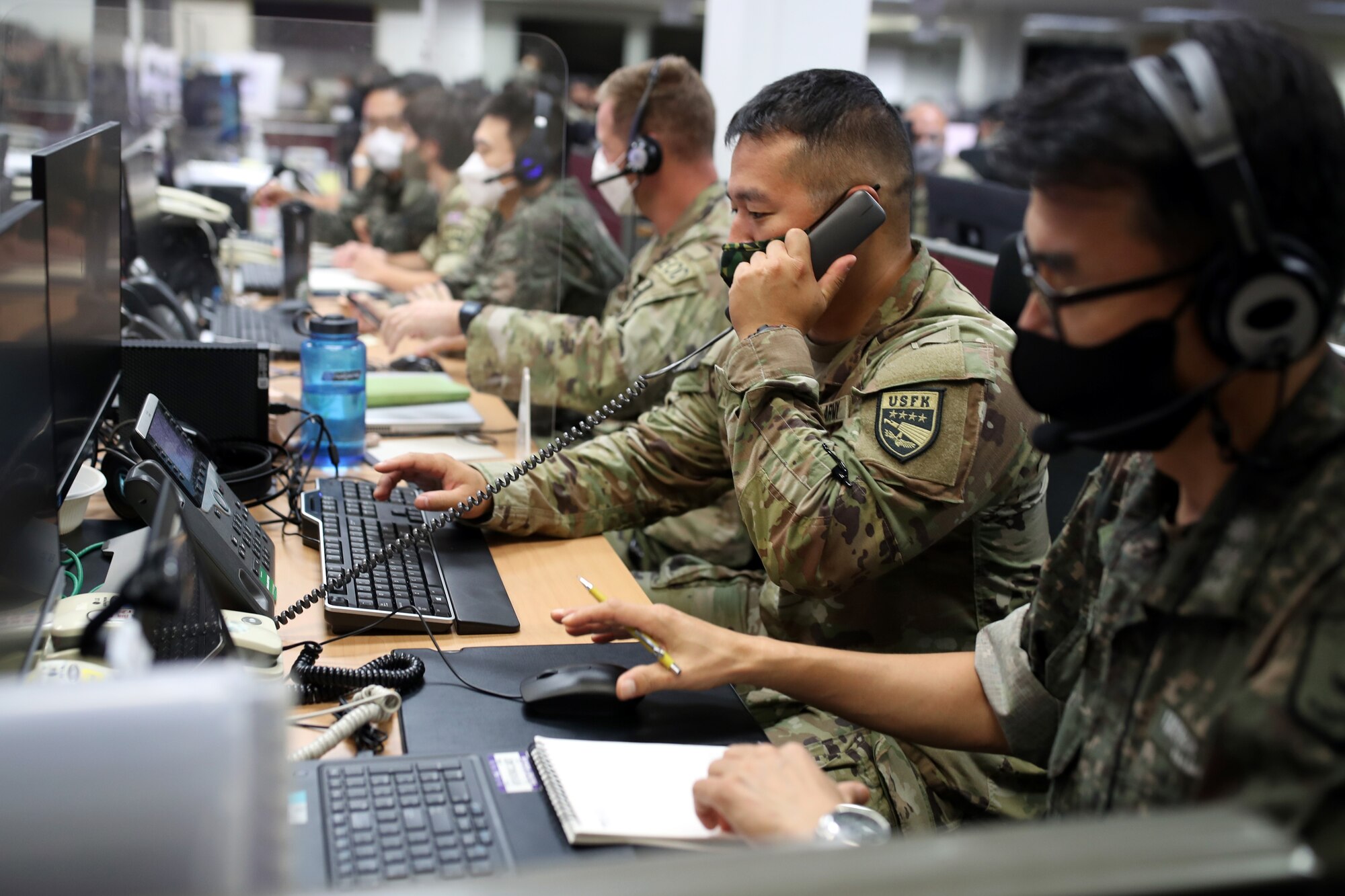 photo of military members working on computers