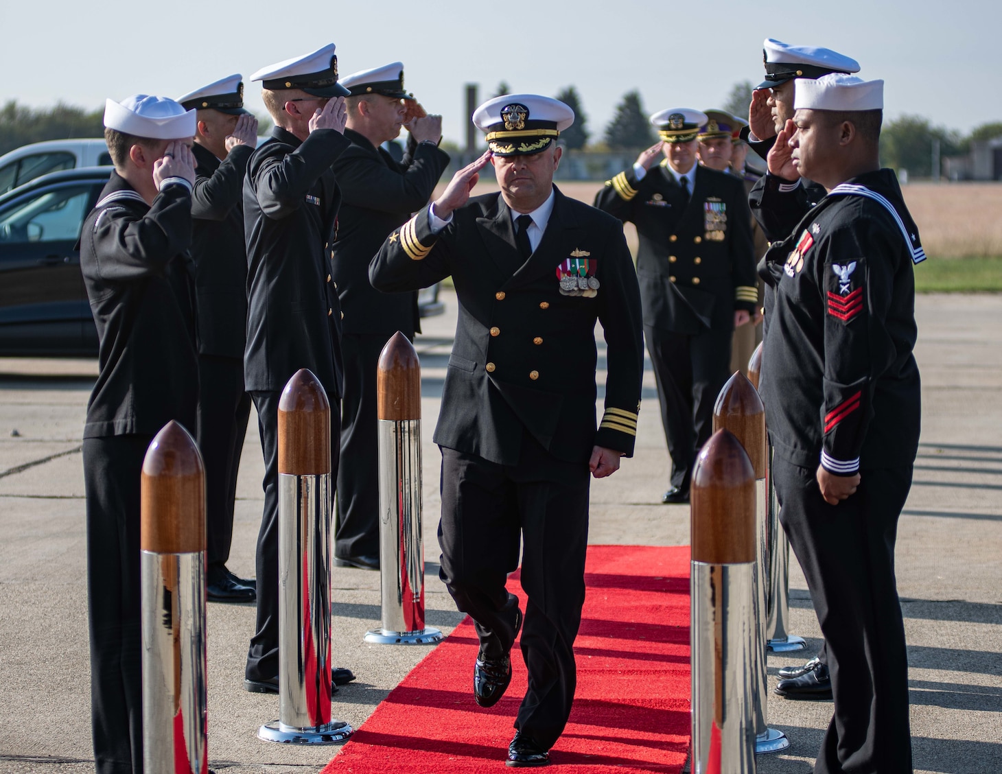 Cmdr. Jonathan P. Schermerhorn renders a hand salute to sideboys during a U.S. Aegis Ashore Missile Defense System Romania (USAAMDSRO) change of command ceremony on Naval Support Facility (NSF) Deveselu, Romania, Oct. 14, 2022.