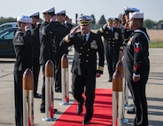 Cmdr. Jonathan P. Schermerhorn renders a hand salute to sideboys during a U.S. Aegis Ashore Missile Defense System Romania (USAAMDSRO) change of command ceremony on Naval Support Facility (NSF) Deveselu, Romania, Oct. 14, 2022.