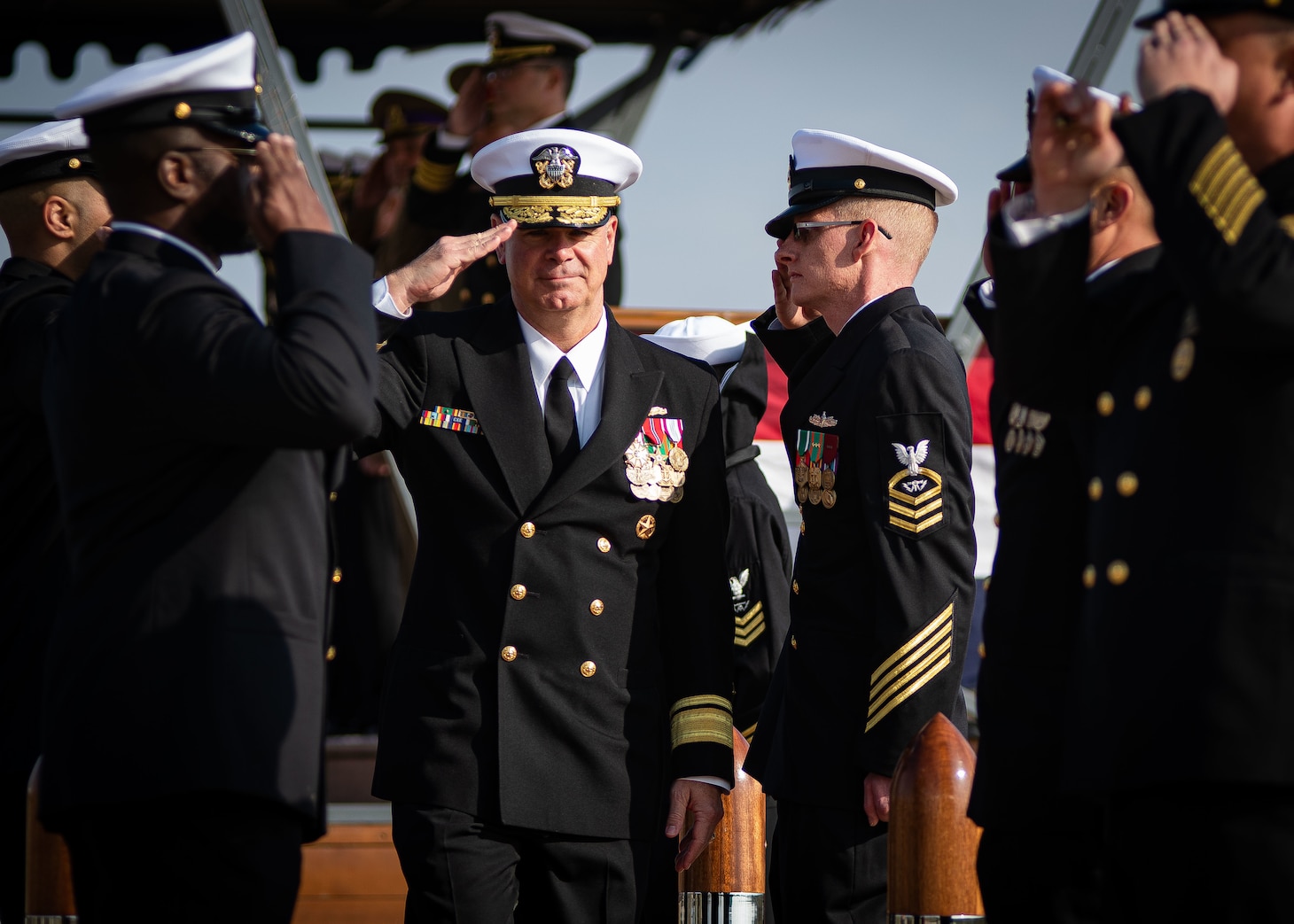 Rear Adm. Brendan McLane, Commander Naval Surface Force Atlantic, renders a hand salute to sideboys during a U.S. Aegis Ashore Missile Defense System Romania (USAAMDSRO) change of command ceremony on Naval Support Facility (NSF) Deveselu, Romania, Oct. 14, 2022.