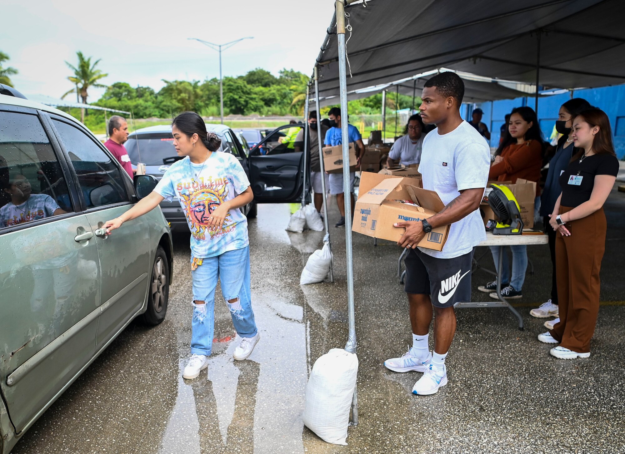 Airmen from the 36th Munitions Squadron volunteer during a food distribution line at the Yigo Gymnasium in Yigo, Guam, Oct. 14, 2022.