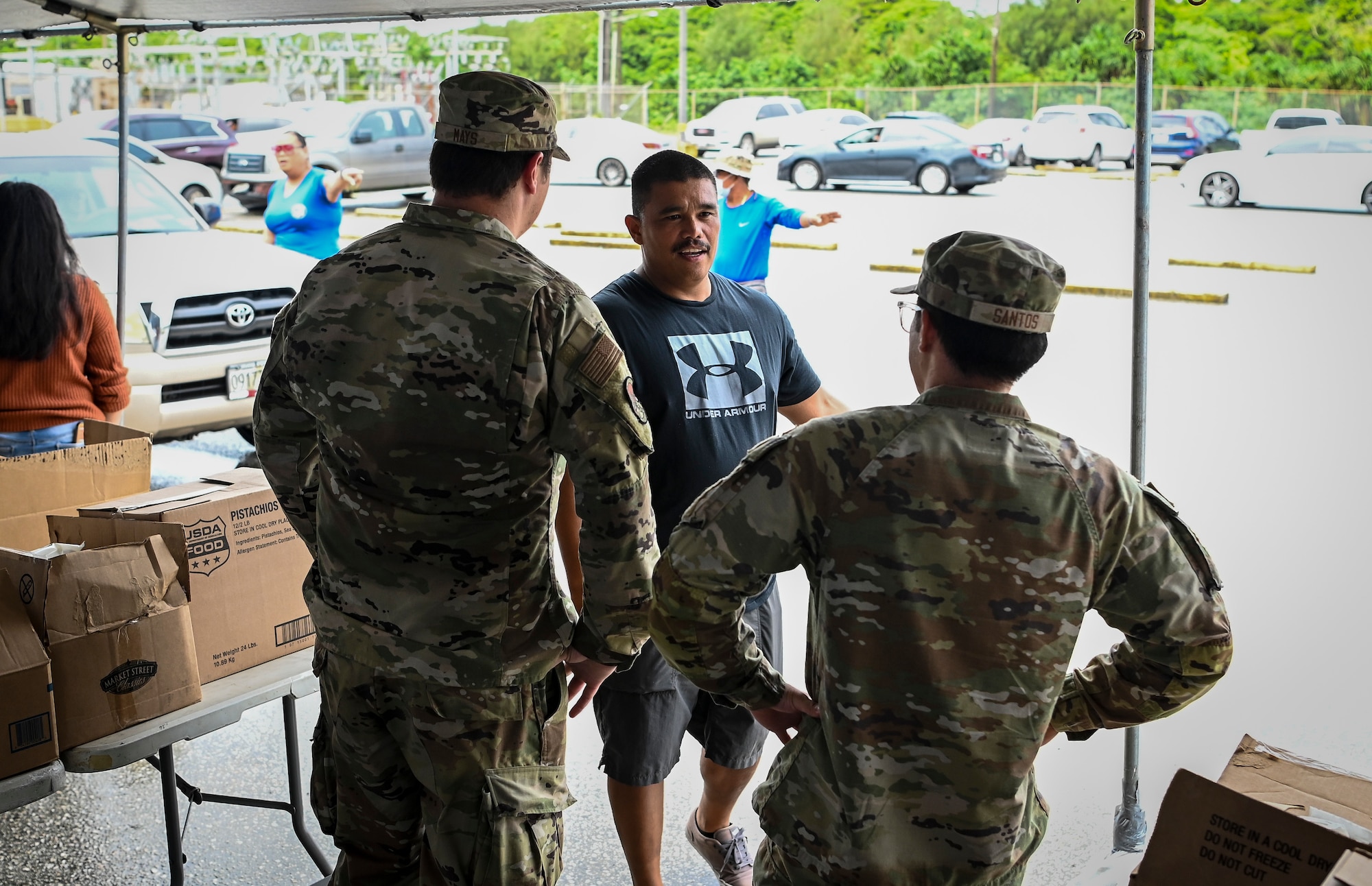 Airmen from the 36th Munitions Squadron volunteer during a food distribution line at the Yigo Gymnasium in Yigo, Guam, Oct. 14, 2022.