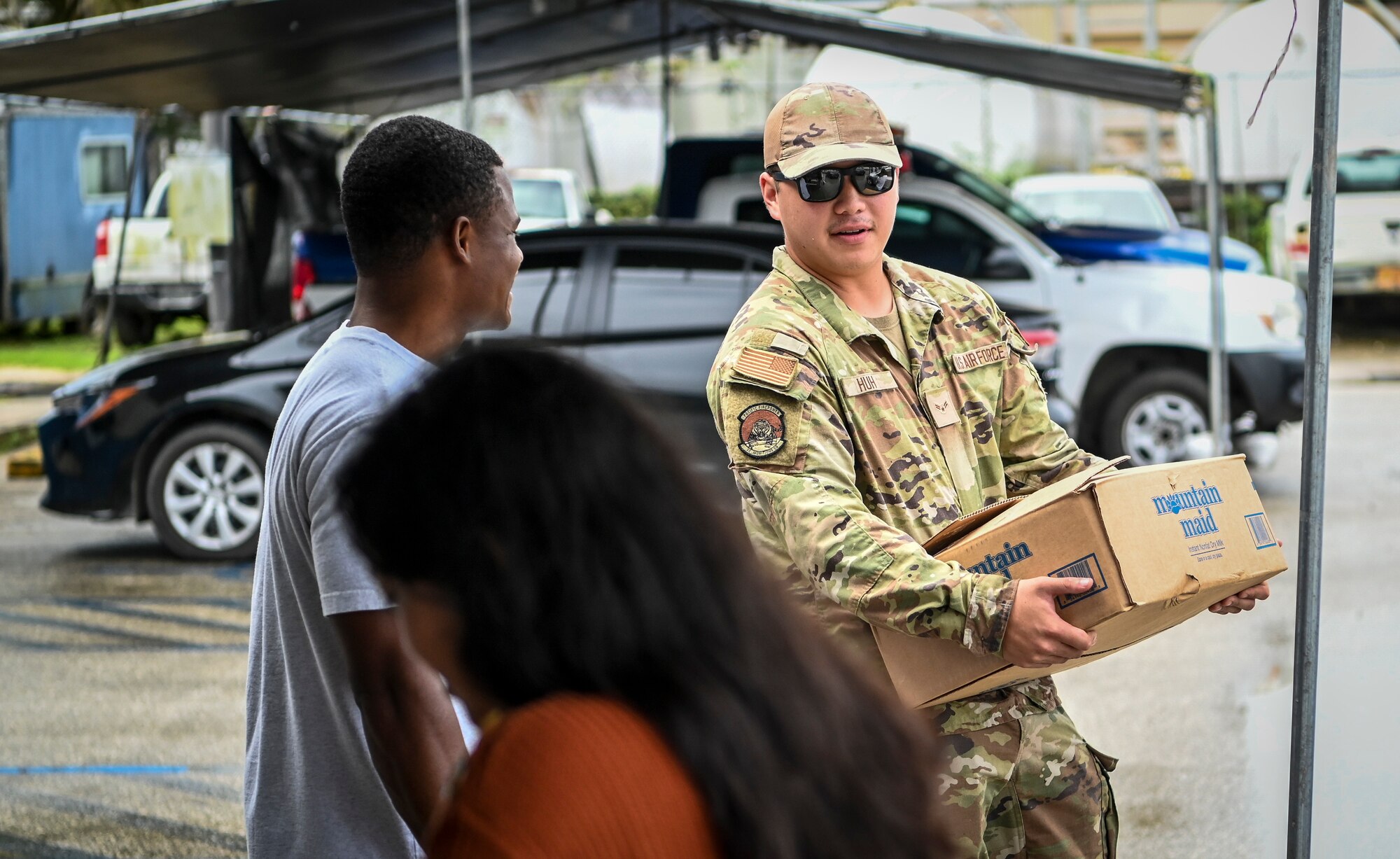 Airmen from the 36th Munitions Squadron volunteer during a food distribution line at the Yigo Gymnasium in Yigo, Guam, Oct. 14, 2022.