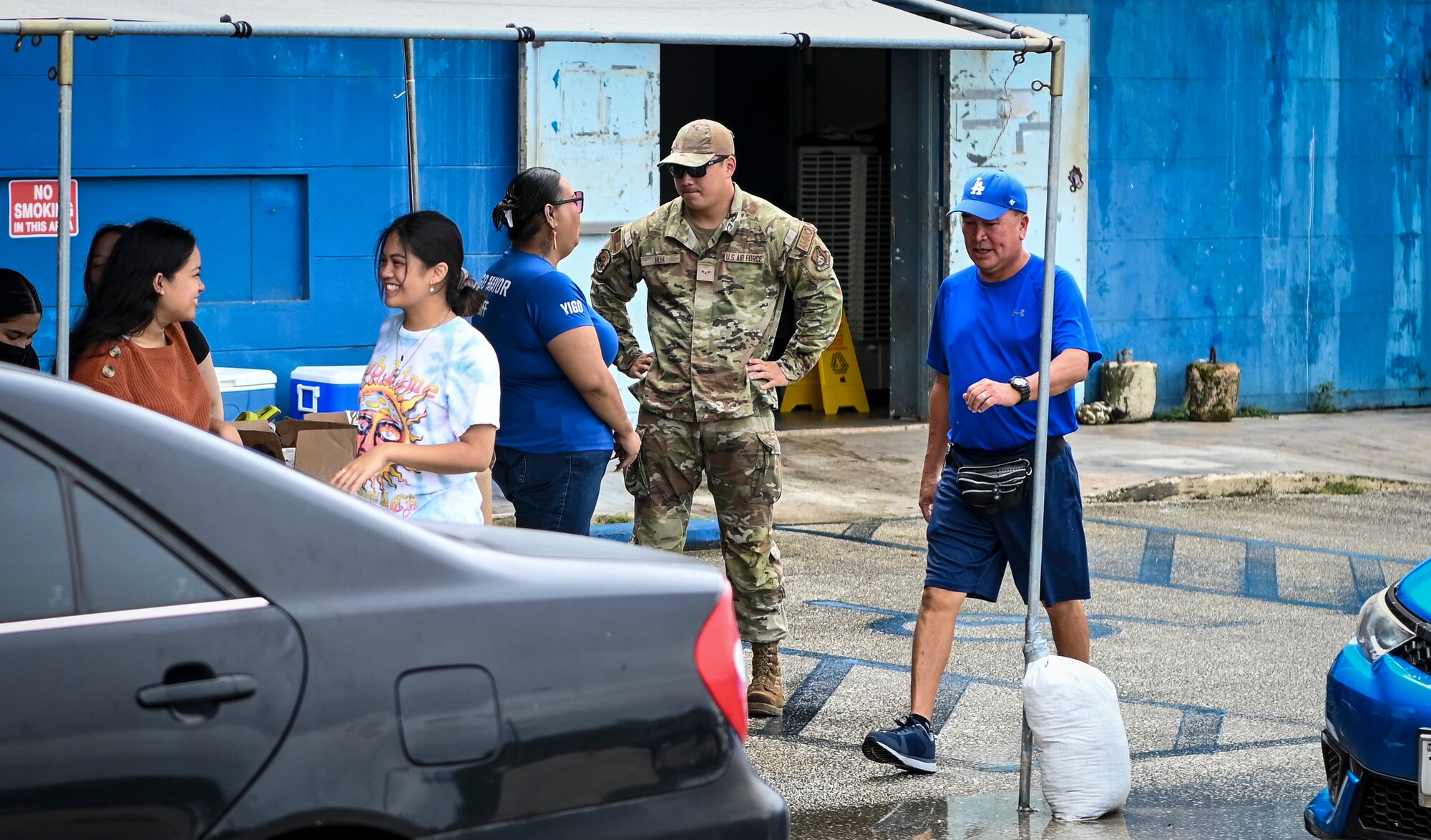 Airmen from the 36th Munitions Squadron volunteer during a food distribution line at the Yigo Gymnasium in Yigo, Guam, Oct. 14, 2022.