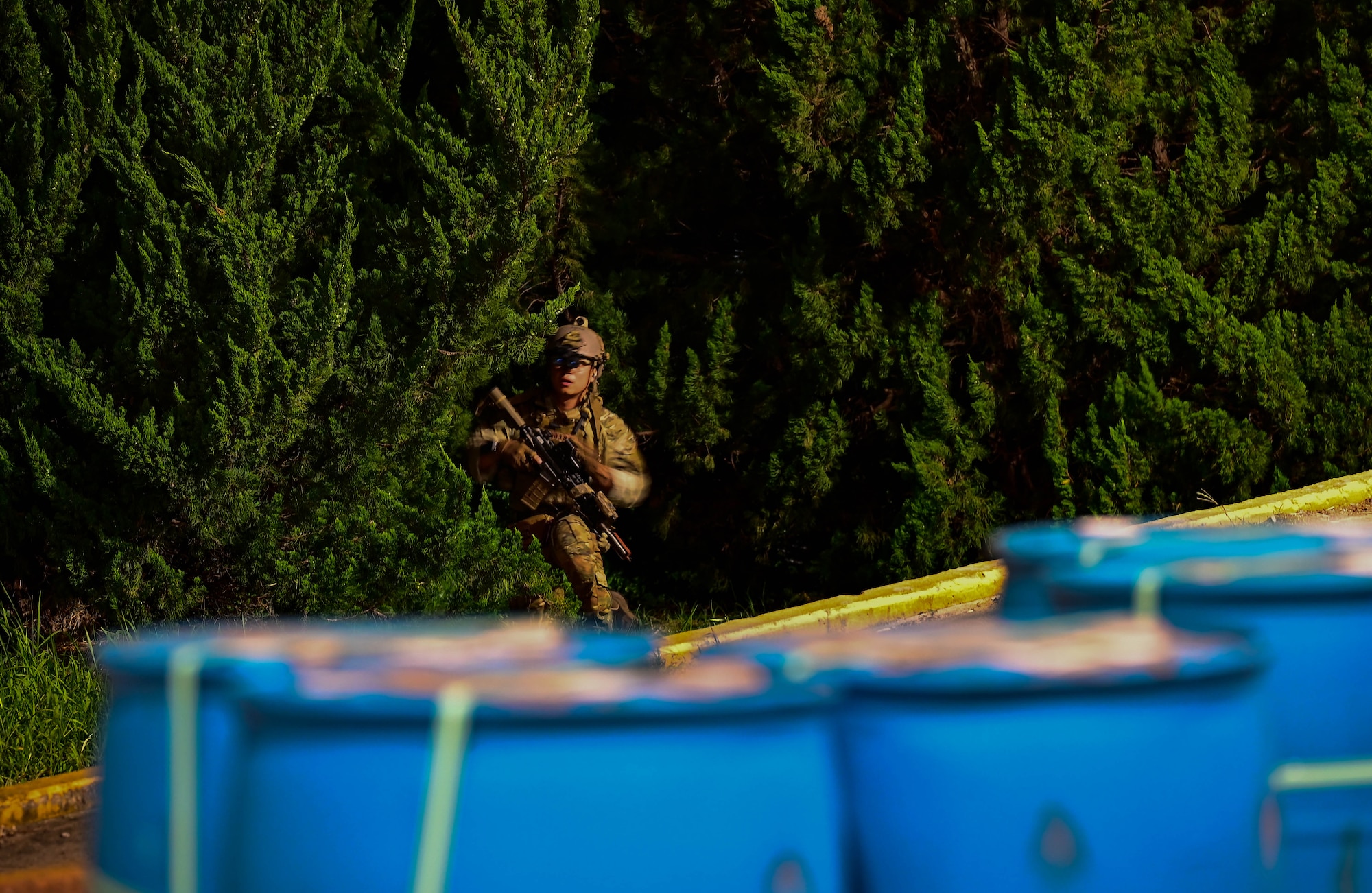 An operator participating in a combined U.S. and Republic of Korea (ROK) special operations forces training, sneaks through the tree line
