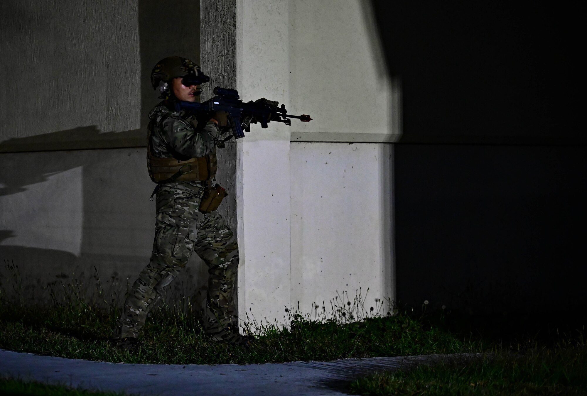 An operator participating in a combined U.S. and Republic of Korea (ROK) special operations forces training, keeps watch after securing a perimeter around a building