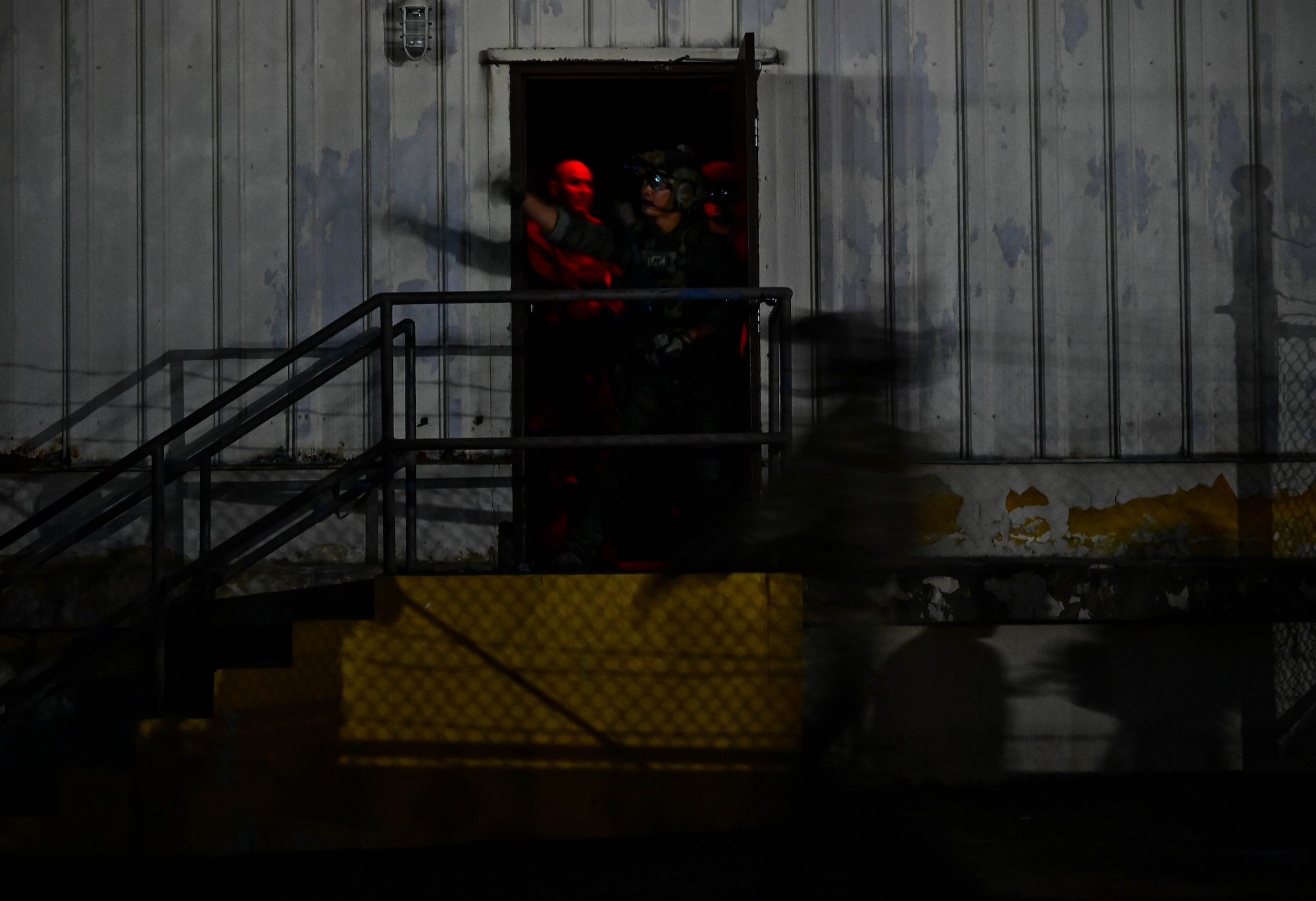 An operator participating in a combined U.S. and Republic of Korea (ROK) special operations forces training, directs others towards opposing forces