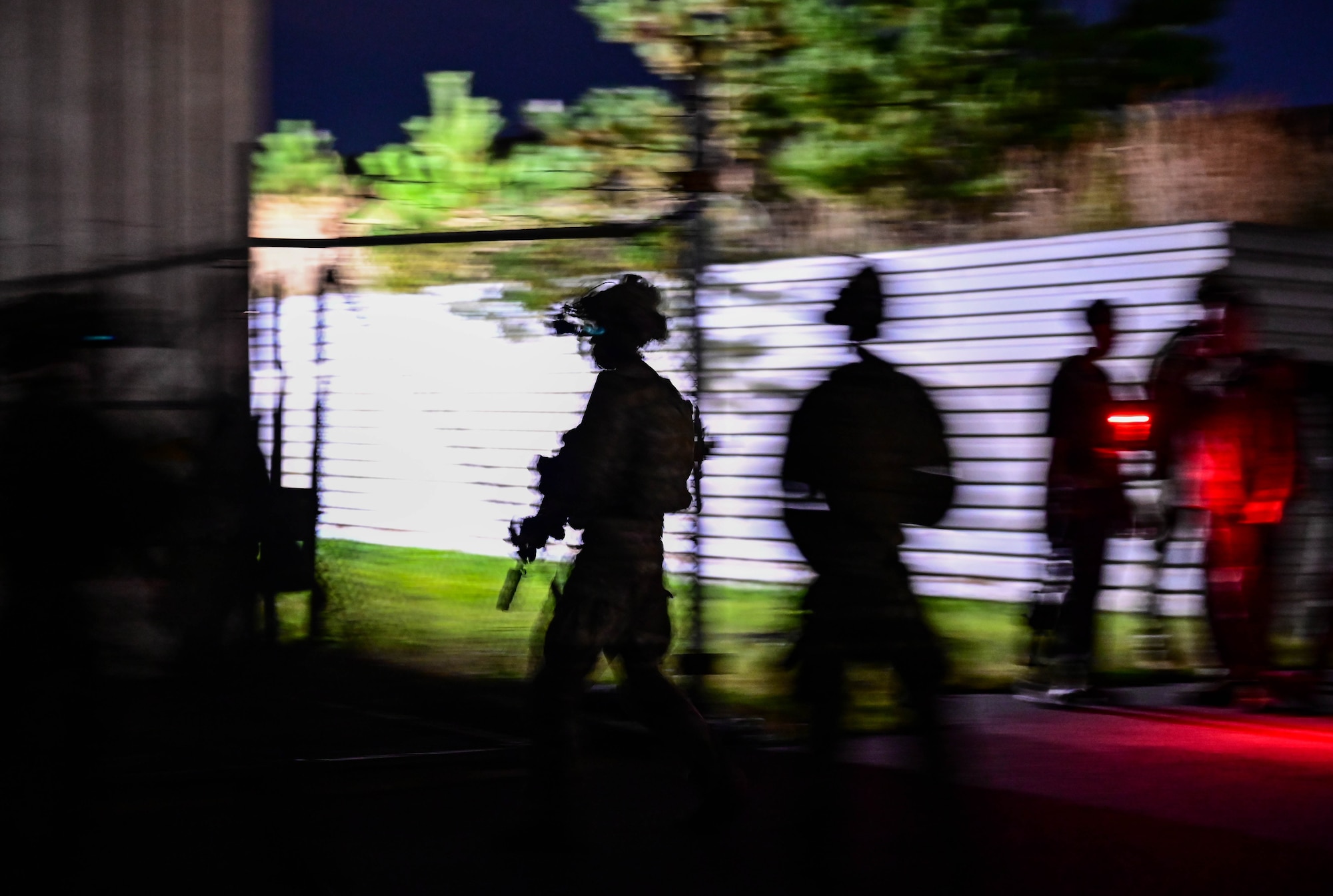 Operators participating in a combined U.S. and Republic of Korea (ROK) special operations forces training, rapidly move between buildings