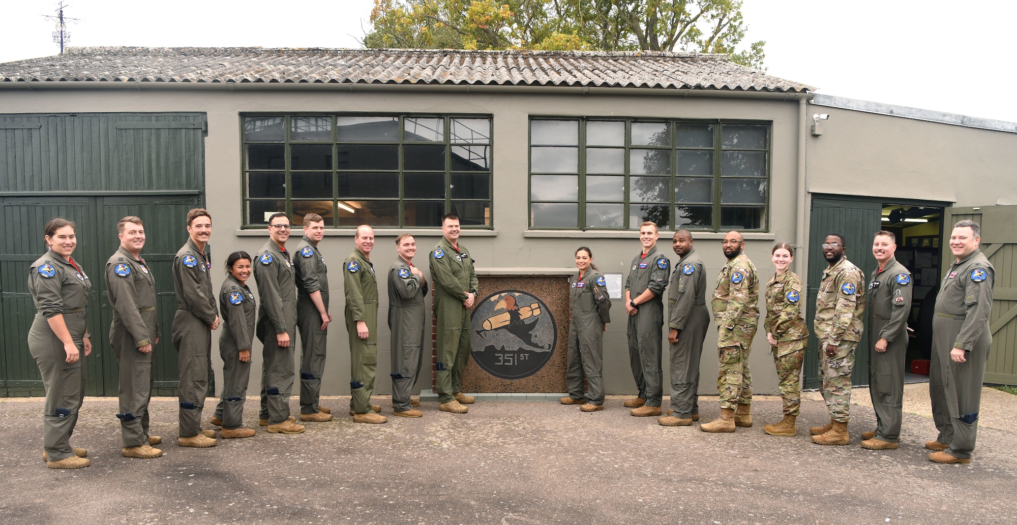Pilots and boom operators from the 351st Air Refueling Squadron show off their newly presented patches after completing mission certification at the 100th Bomb Group Memorial Museum at Thorpe Abbotts, England, Oct. 14, 2022. Thorpe Abbotts was home to the original 351st Bomb Squadron and 100th Bomb Group during World War II. The “Buzzard” patch is a heritage patch and only those who have completed MCT can wear the patch on Fridays. Two squadron aviation resource management Airmen were also presented a patch after completing their training on a variety of tasks including keeping vital flight records and orders. (U.S. Air Force photo by Karen Abeyasekere)
