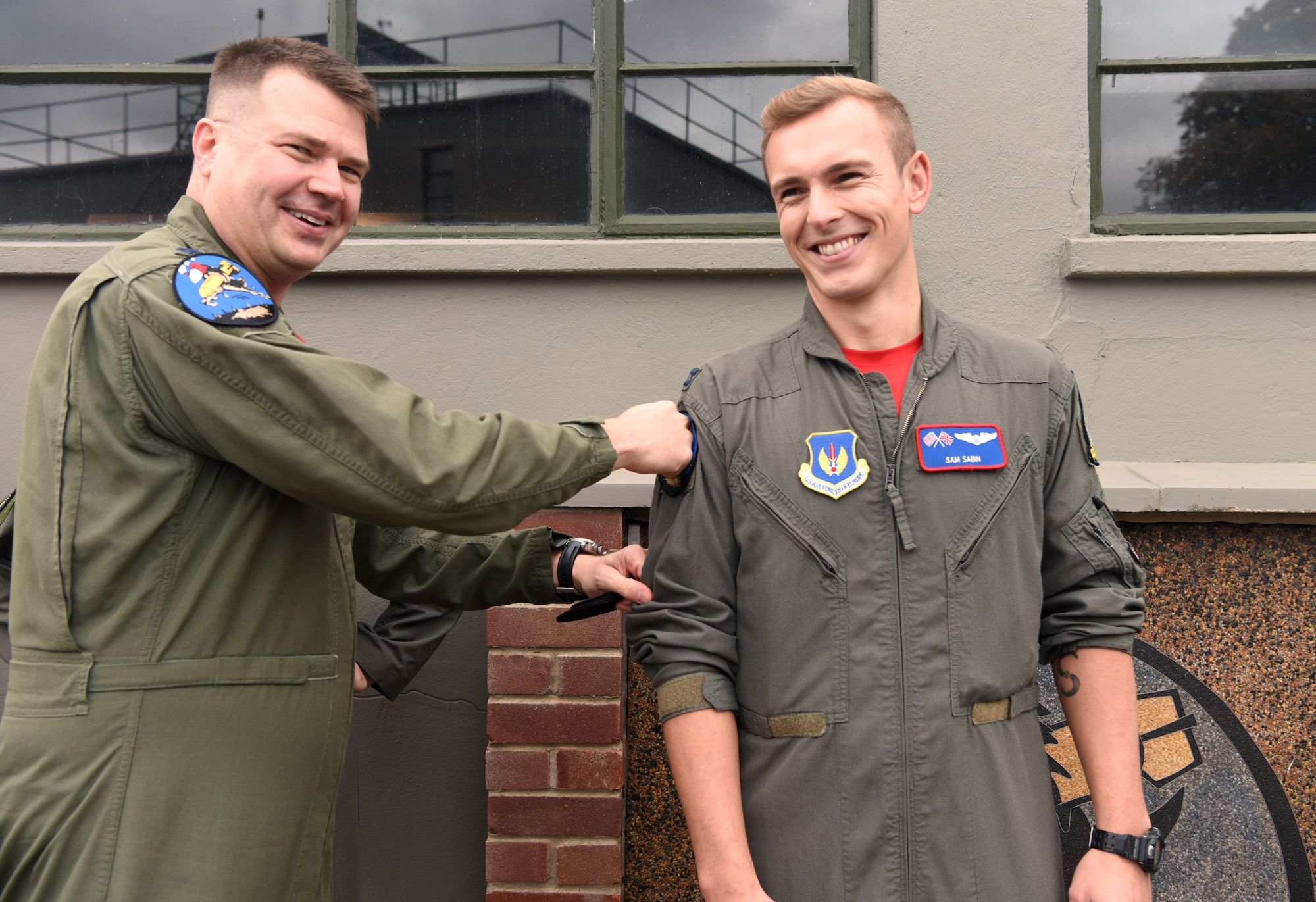 U.S. Air Force Lt. Col. Tyler Berge, left, 351st Air Refueling Squadron commander, presents the squadron heritage “Buzzard” patch to Capt. Sam Sabin, 351st ARS executive officer, at the 100th Bomb Group Memorial Museum, Thorpe Abbotts, England, Oct. 14, 2022. The Buzzard heritage patch is presented to pilots and boom operators who have completed mission certification training. Thorpe Abbotts was home to the original 351st Bomb Squadron and 100th Bomb Group during World War II. (U.S. Air Force photo by Karen Abeyasekere)
