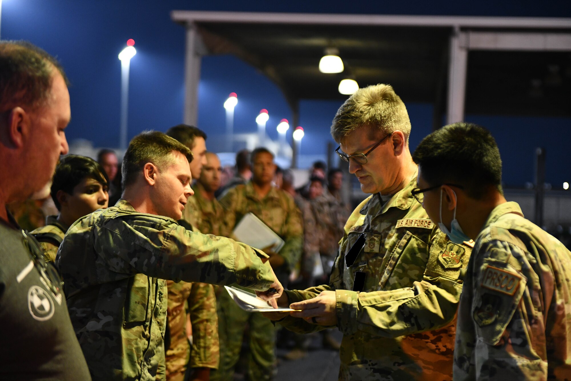 Members of the 379th Expeditionary Force Support Squadron Personnel Support for Contingency Operations team in-process incoming personnel on Al Udeid Air Base, Qatar, Oct. 14, 2022. The Reception Control Center ensures records are properly maintained for inbound personnel. (U.S. Air National Guard photo by Airman 1st Class Constantine Bambakidis) (Photo was modified for security purposes)