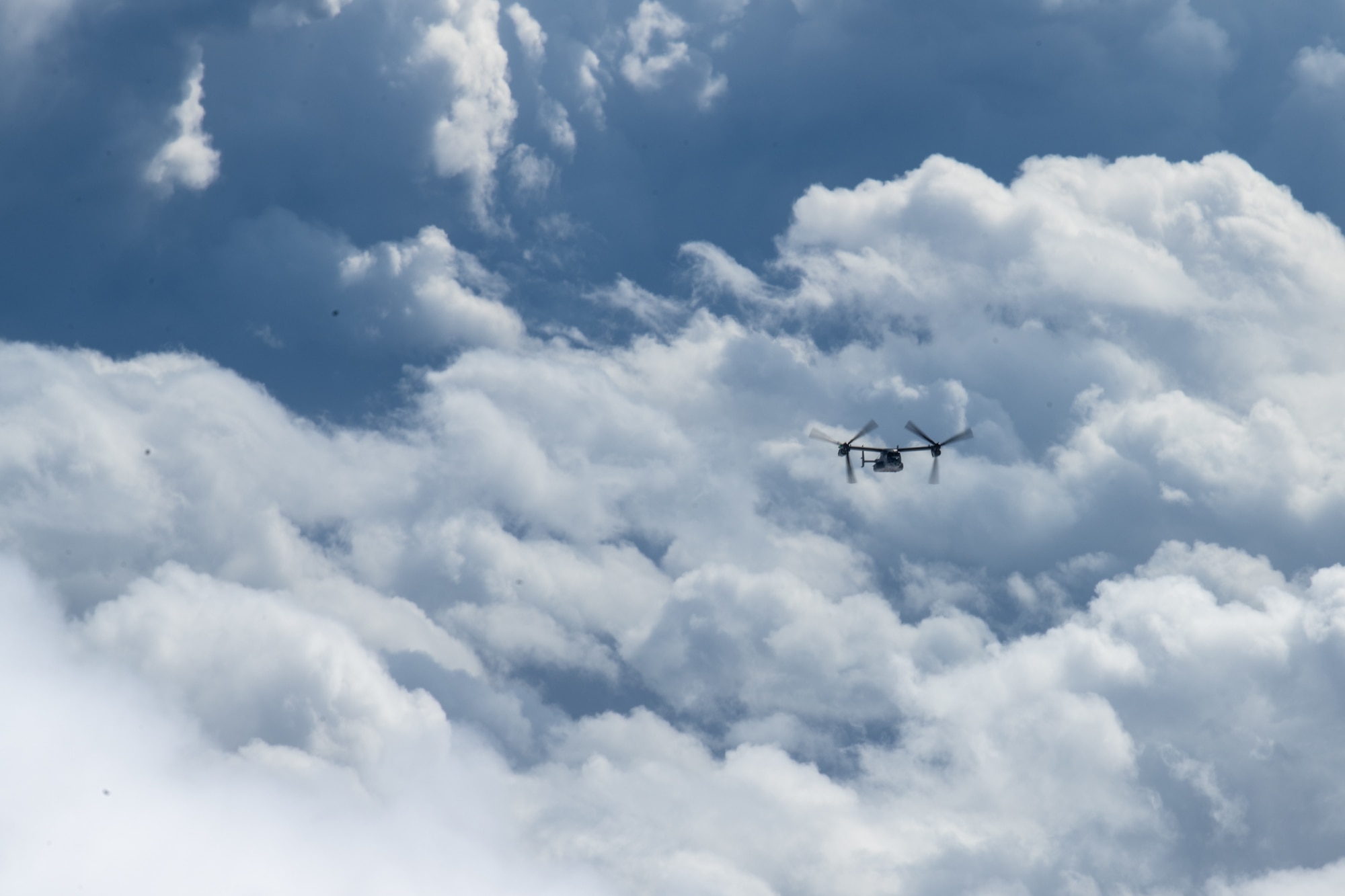 A CV-22 Osprey flies in clouds