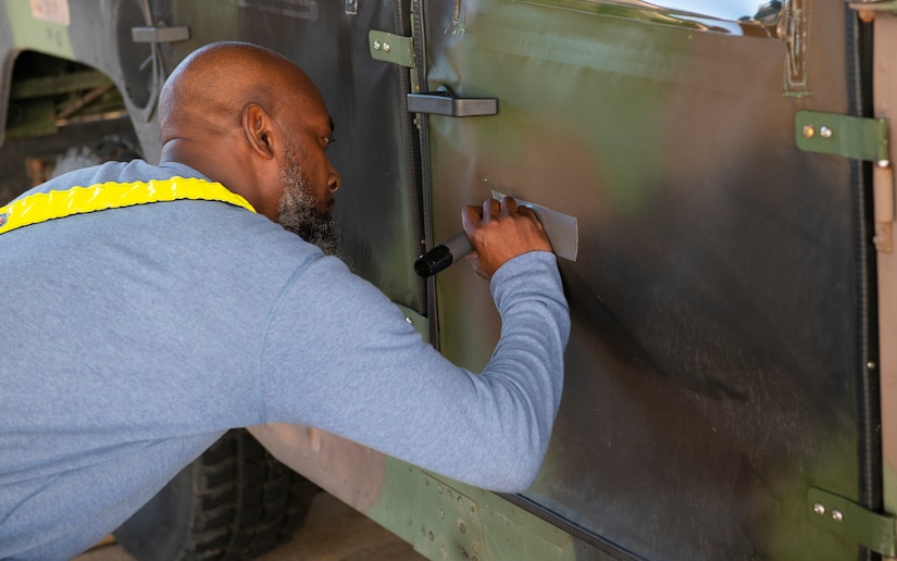 Air Force personal inspects a Humvee