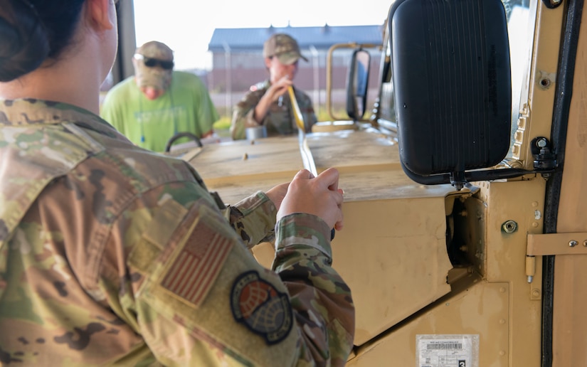 Airmen measure a Humvee