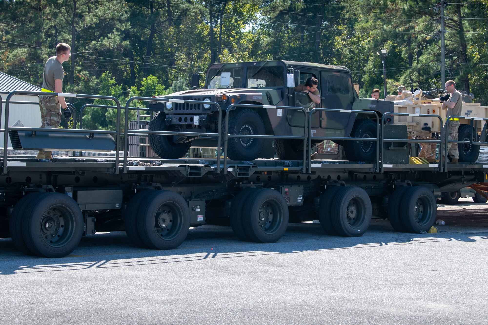 Airmen prepare to tie down equipment