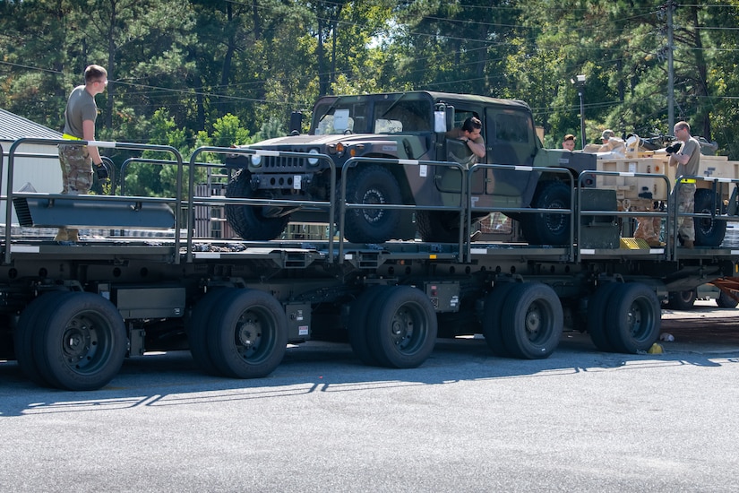 Airmen prepare to tie down equipment