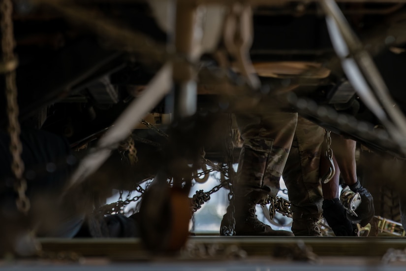 An Airman ties down a Humvee