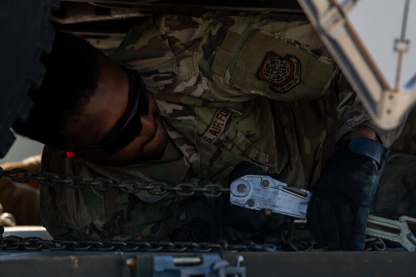 An Airman ties down a Humvee