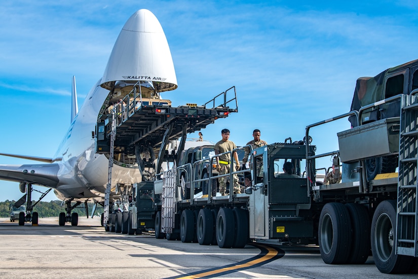 Trailers and Humvees are loaded on to a Boeing 747