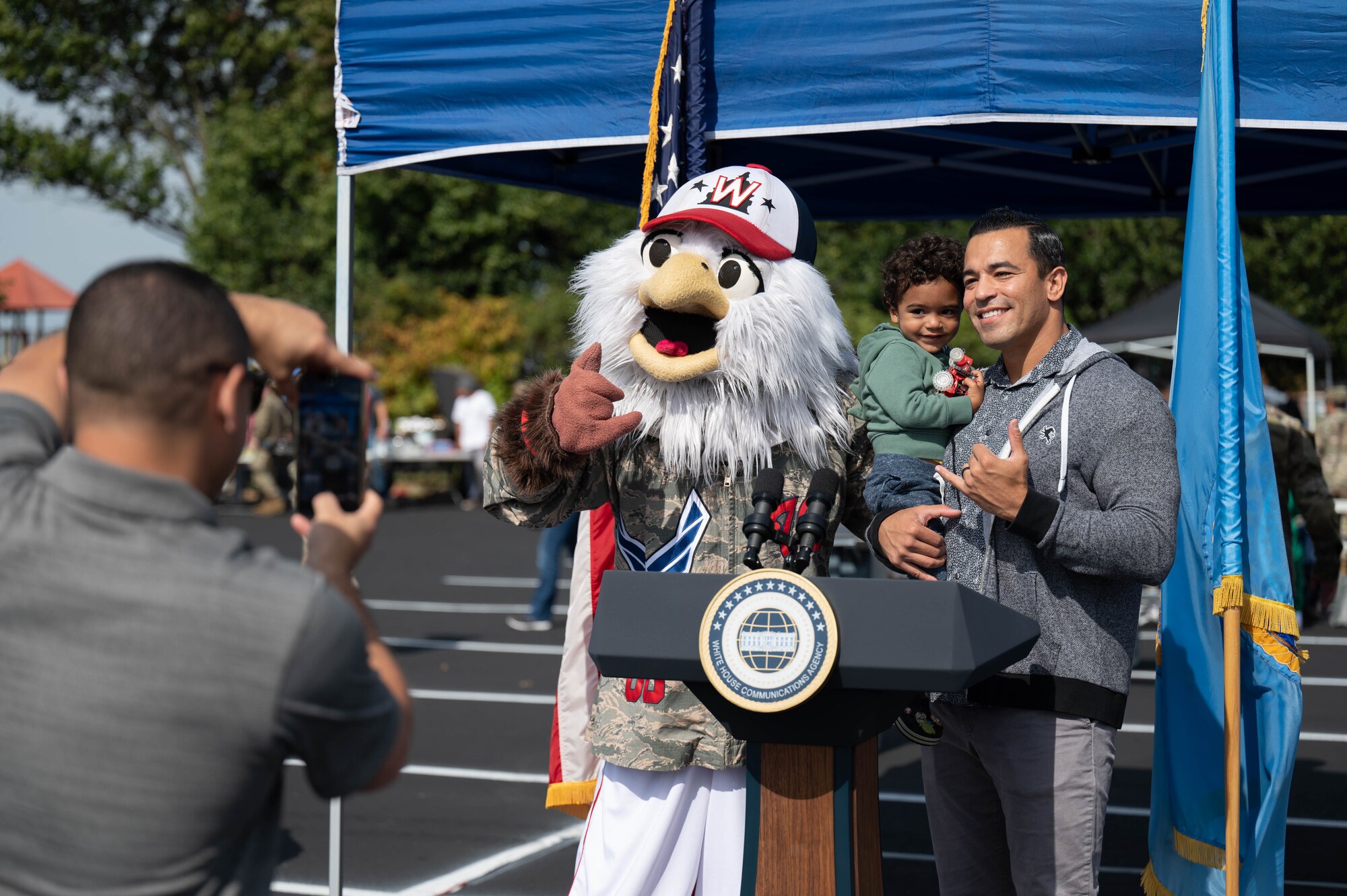 Maj. Ralph Soto and Lucas Soto pose with "Screech," the Washington Nationals' mascot, at the Sentinels Celebration, Joint Base Anacostia-Bolling, Washington, D.C., Oct. 12, 2022. Mission partners and units across the National Capital Region came together to celebrate the base reaching Full Operational Capability after the first-ever Department of Defense lead service transfer in 2020. (U.S. Air Force photo by Kristen Wong)