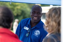 Basil Forrest, Military and Readiness Center Community Readiness Supervisor, speaks with attendees about services available through the M&FRC at the Sentinels Celebration, Joint Base Anacostia-Bolling, Washington, D.C., Oct. 12, 2022. The Sentinels Celebration hosted a variety of booths from units on JBAB and mission partners across the National Capital Region. (U.S. Air Force photo by Kristen Wong)