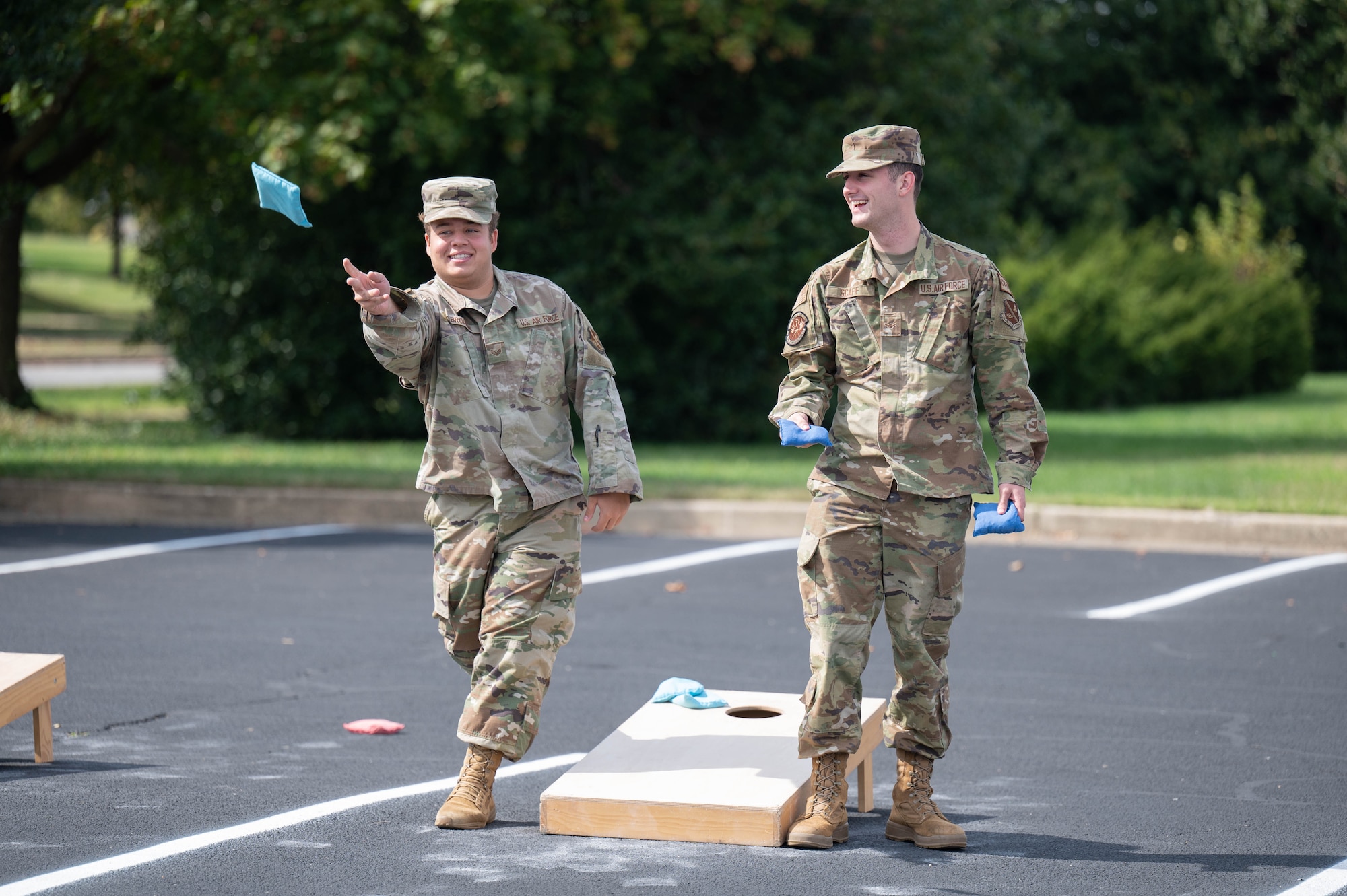 Senior Airman Christian Brodeur and Airman Kyler Scaff play a game of corn hole at the Sentinels Celebration, Joint Base Anacostia-Bolling, Washington, D.C., Oct. 12, 2022. The Sentinels Celebration was held in honor of the base reaching Full Operational Capability after the first-ever Department of Defense lead service transfer in 2020. (U.S. Air Force photo by Kristen Wong)