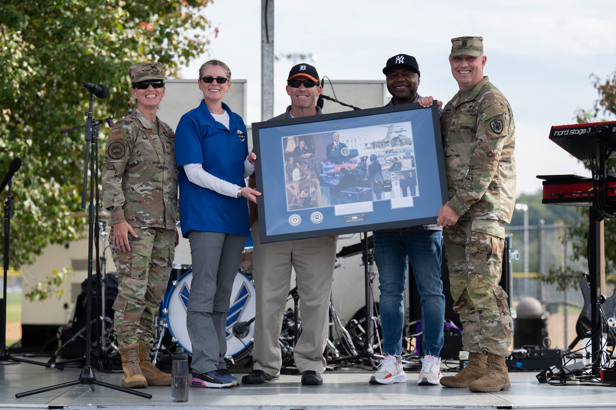 U.S. Air Force Col. Joy Kaczor and U.S. Army Command Sgt. Maj. Sean Mitcham of the White House Communication Agency present a commemorative frame to the 11th Wing command team at the Sentinels Celebration, Joint Base Anacostia-Bolling, Washington, D.C., Oct. 12, 2022. Mission partners and units across the National Capital Region came together to celebrate the base reaching Full Operational Capability after the first-ever Department of Defense lead service transfer in 2020. (U.S. Air Force photo by Kristen Wong)