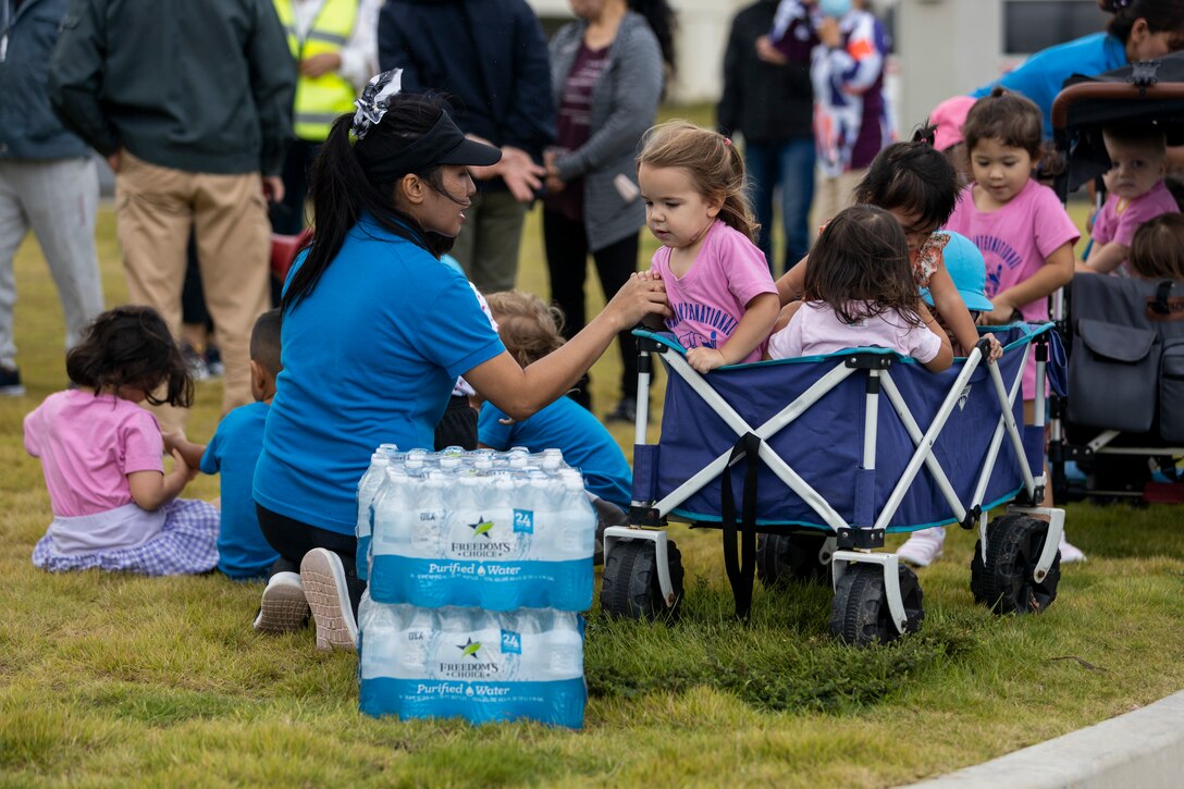 A participant tends to children during a tsunami evacuation drill during Exercise Constant Vigilance 2022 on Camp Hansen, Okinawa, Japan, Oct. 18, 2022. The annual drill was held to convey the readiness and capabilities of various installations and first responders in the event of an emergency. CV22 is a Force Protection Condition and crisis response evaluation to validate regional installations, camps, and tenant antiterrorism plans and policies. (U.S. Marine Corps photo by Lance Cpl. Thomas Sheng)