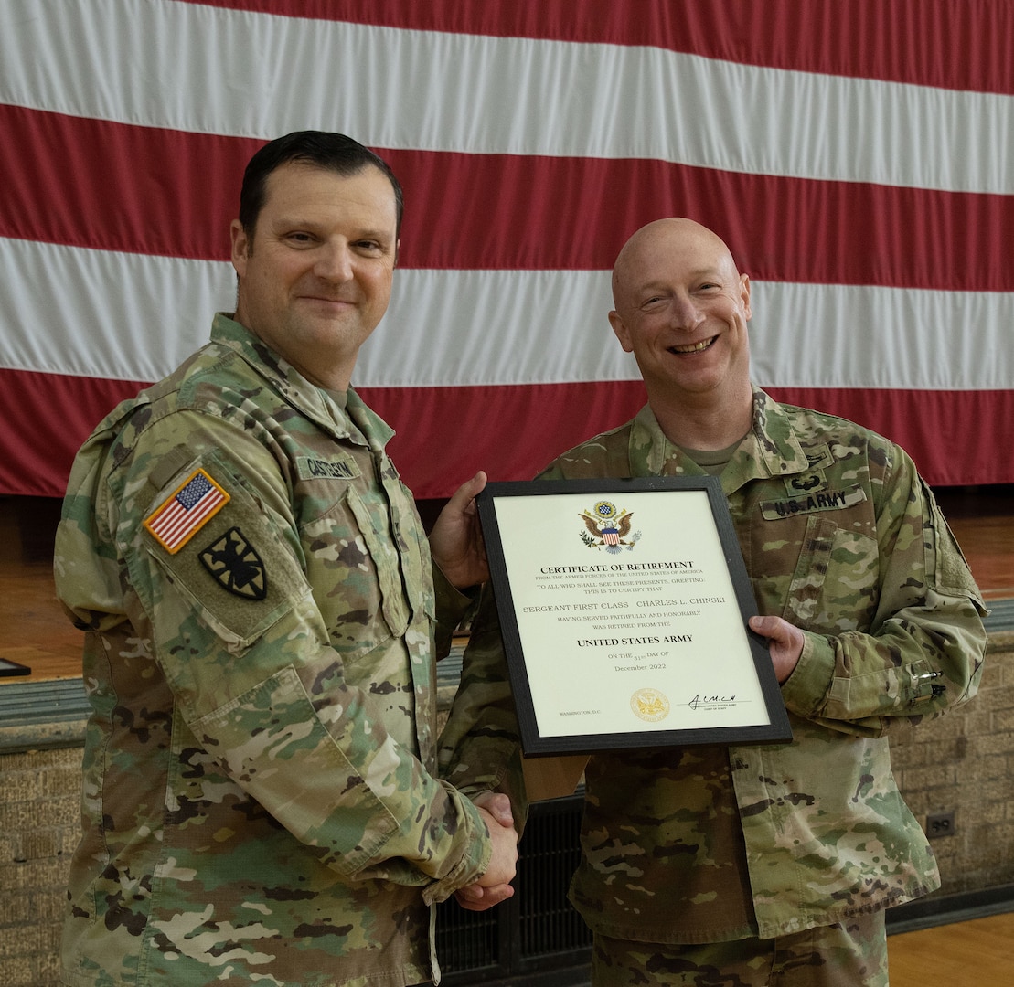 Sgt. 1st Class Charles Chinski, of Bourbonnais, Illinois, 244th Digital Liaison Detachment, based in Chicago, is presented a certificate of retirement by Col. Max Casteleyn, commander, 244th DLD, during a retirement ceremony Oct. 16 at the Northwest Armory in Chicago.