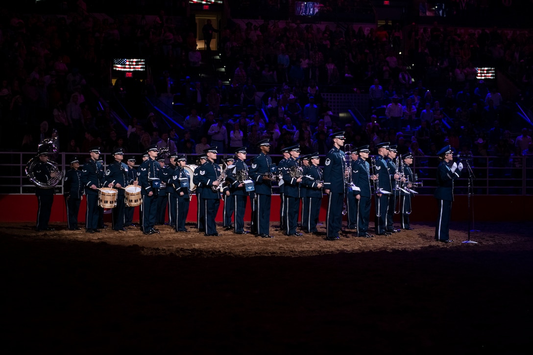 Band standing in rodeo stadium