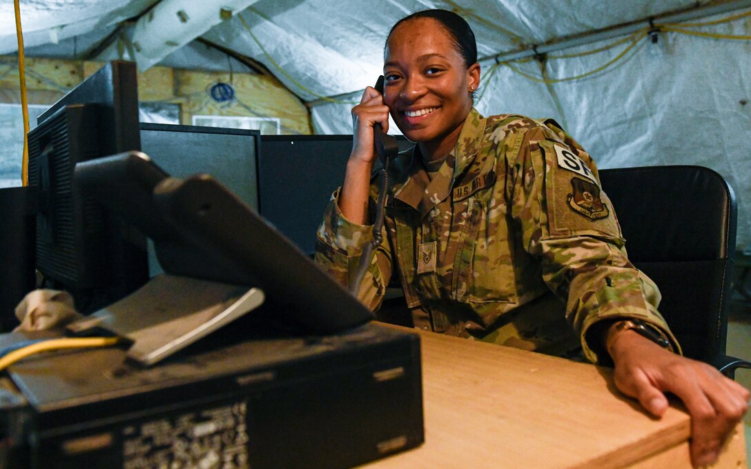 U.S. Air Force Staff Sgt. Deandrea Quarles, a dispatcher assigned to the 378th Expeditionary Security Forces Squadron, takes a call at Prince Sultan Air Base, Kingdom of Saudi Arabia, Oct. 6, 2022. Quarles is a Reserve Citizen Airmen assigned to the 307th Security Forces Squadron from Barksdale Air Force Base, Louisiana. Active-duty members and Reservists within the 378th ESFS work with the 1-182nd Infantry Regiment‘s Task Force Americal’s Massachusetts National Guardsmen completing the trifecta of PSAB’s Total Force protection. (U.S. Air Force photo by Staff Sgt. Noah J. Tancer)