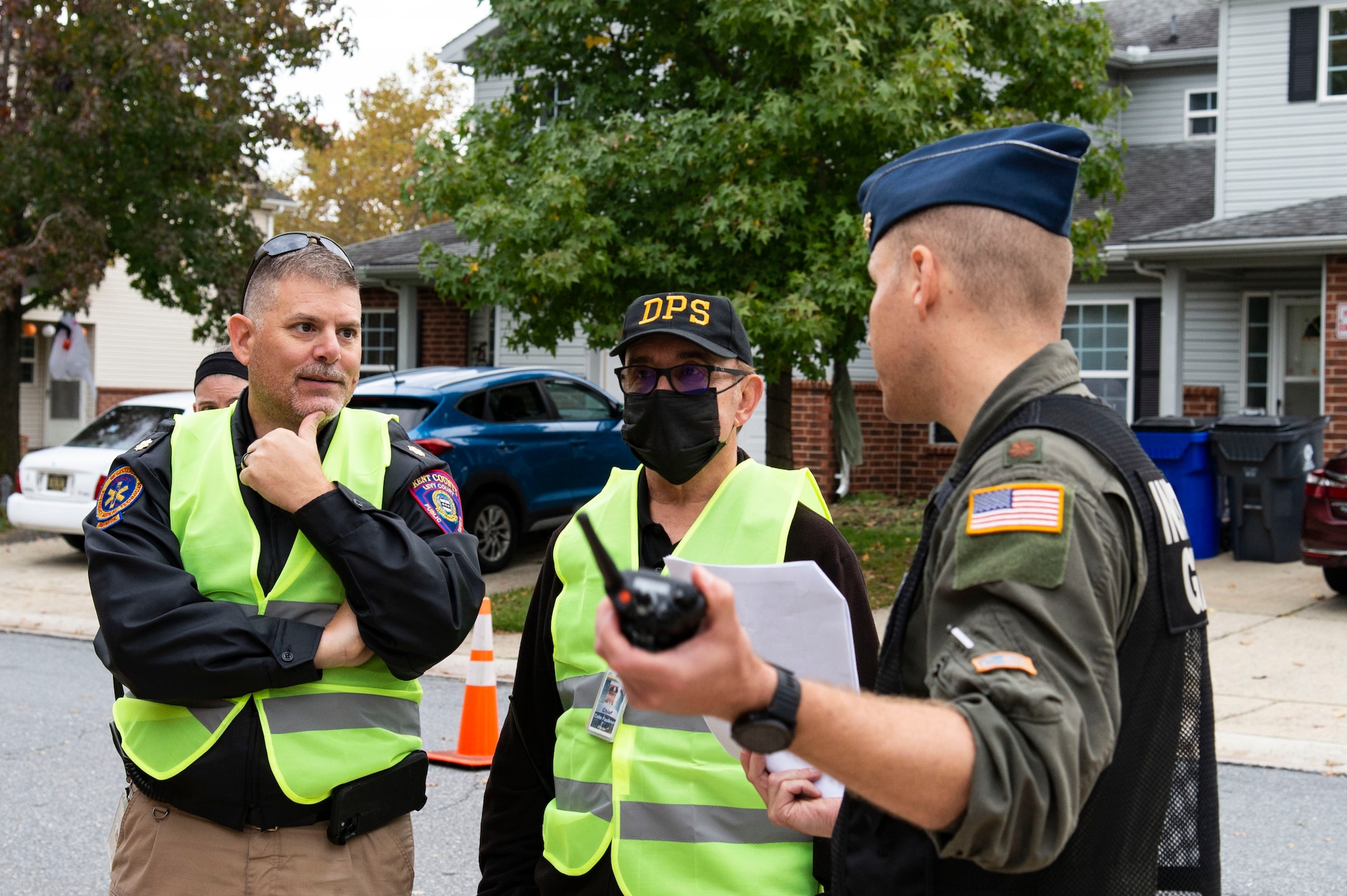 Maj. Zackery Williams, right, 436th Airlift Wing Inspector General chief of wing inspections, talks with representatives from local agencies prior to the start of an active shooter exercise held at Dover Air Force Base, Delaware, Oct. 14, 2022. The exercise involved numerous base and community first responders that worked together to neutralize the simulated active shooter during this joint training exercise. (U.S. Air Force photo by Roland Balik)