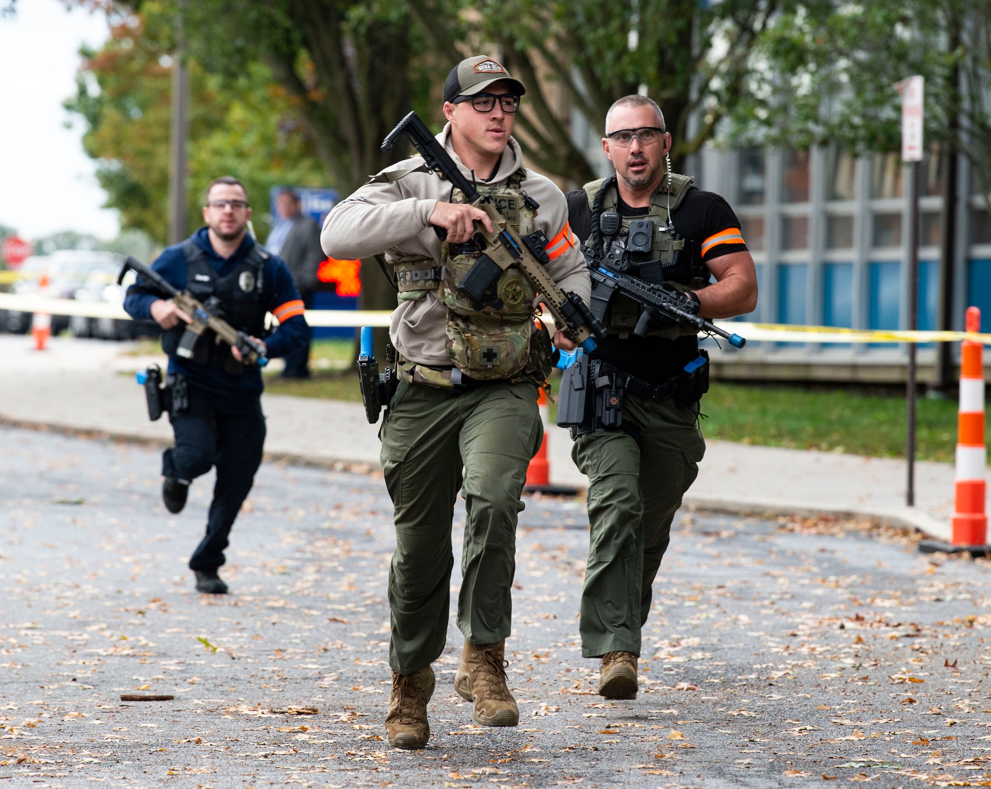 First responders from the local community run toward the main entrance of Maj. George S. Welch Elementary and Dover Air Base Middle Schools during an active shooter exercise at Dover Air Force Base, Delaware, Oct. 14, 2022. The exercise involved numerous base and community first responders working together to neutralize the simulated active shooter. (U.S. Air Force photo by Roland Balik)