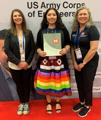 Beth Coffey, Northwestern Division program director, right, and Corina Zhang an Omaha senior resident engineer, left, present a letter of intent to Madison Phelps, a civil engineer major from the South Dakota School of Mines and Technology, during the American Indian Science and Engineering Society National Conference Oct. 7 at the Palm Springs Convention Center in California.