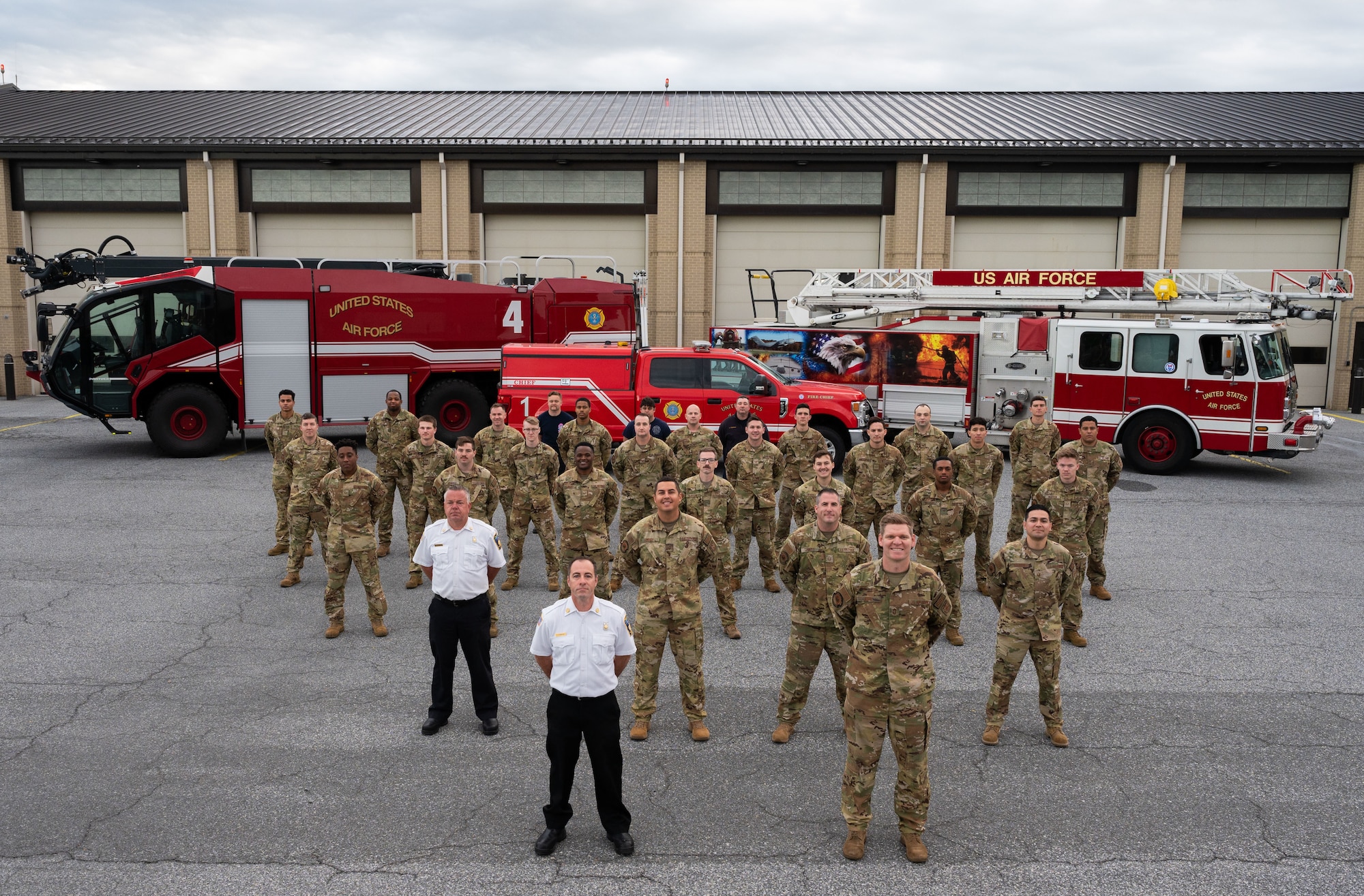 Members of the 436th Civil Engineer Squadron fire department pose for a photo Oct. 18, 2022, at Dover Air Force Base, Delaware. The fire department hosted several events for the 100th anniversary of Fire Prevention Week, including an open house, a parade and a fire muster physical training. (U.S. Air Force photo by Senior Airman Cydney Lee)