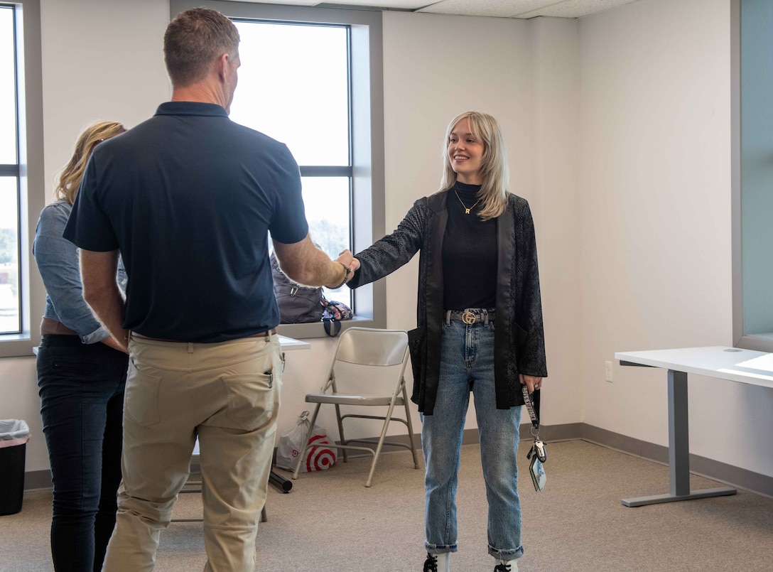 John Nash, Secretary of Military and Veteran Affairs of Oklahoma, meets Lexi Duran, a military spouse at the coworking space in Altus, Oklahoma, Oct. 11, 2022. Members of the 97th Air Mobility Wing took Nash downtown to meet with military spouses and see what programs Altus Air Force Base offers families of Airmen. (U.S. Air Force photo by Airman 1st Class Kari Degraffenreed)