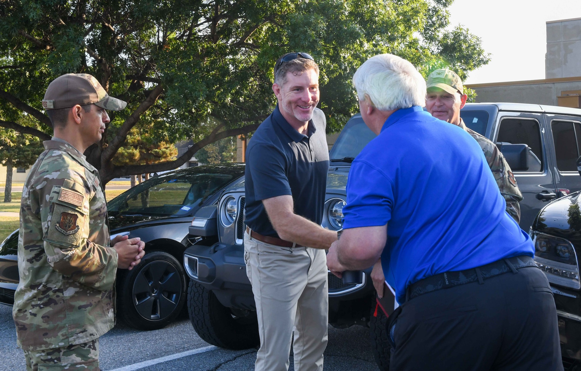 John Nash, Secretary of Military and Veteran Affairs of Oklahoma (center) shakes hands with Robert Cox, a member of the Oklahoma Strategic Military Planning Commission, at Altus Air Force Base, Oklahoma, Oct. 11, 2022. Nash is an Oklahoma native who played basketball at 
the University of Oklahoma before commissioning as an officer with the U.S. Army. (U.S. Air Force photo by Airman 1st Class Kari Degraffenreed)