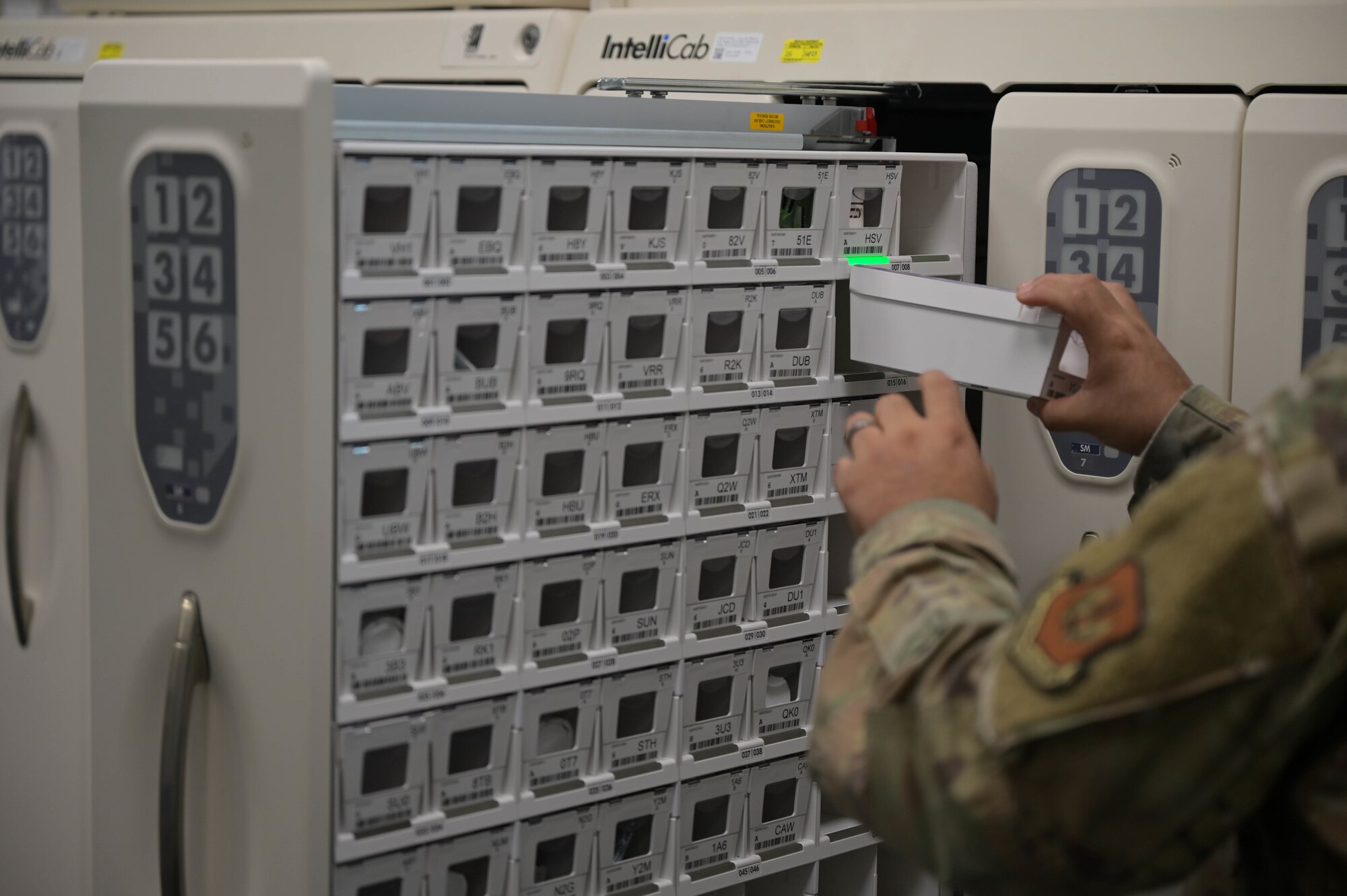 U.S. Air Force Tech. Sgt. Arturo Silva Sanchez, 86th Medical Support Squadron noncommissioned officer in charge of the Kaiserslautern Military Community Center Satellite Pharmacy, loads bins of prescriptions into a medication storage system at Ramstein Air Base, Germany, Oct. 4, 2022.