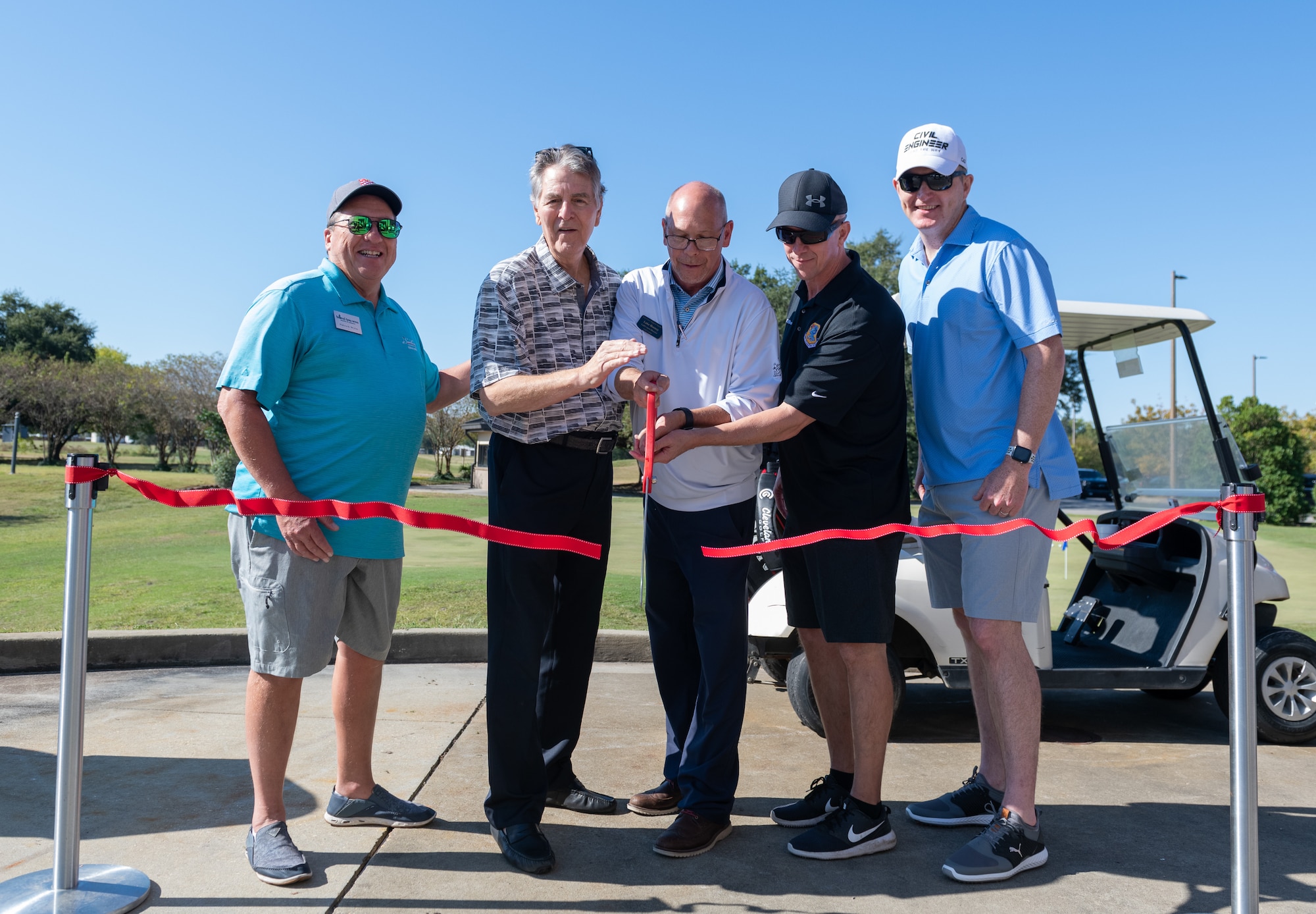 Col. William H. Hunter, 81st Training Wing commander, Luke Rooney, golf course director and honored guest, cut the ribbon during the Bay Breeze Golf Course reopening ceremony at the Bay Breeze Event Center on Keesler Air Force Base, Mississippi, Oct. 14, 2022. The Ribbon Cutting Ceremony was followed by a four player scramble, prizes for teams, food and drinks. (U.S. Air Force Photo by Andre' Askew)