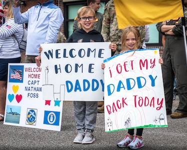 Family members prepare to greet returning Airmen