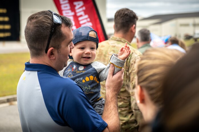 Family members prepare to greet Airmen returning from deployment