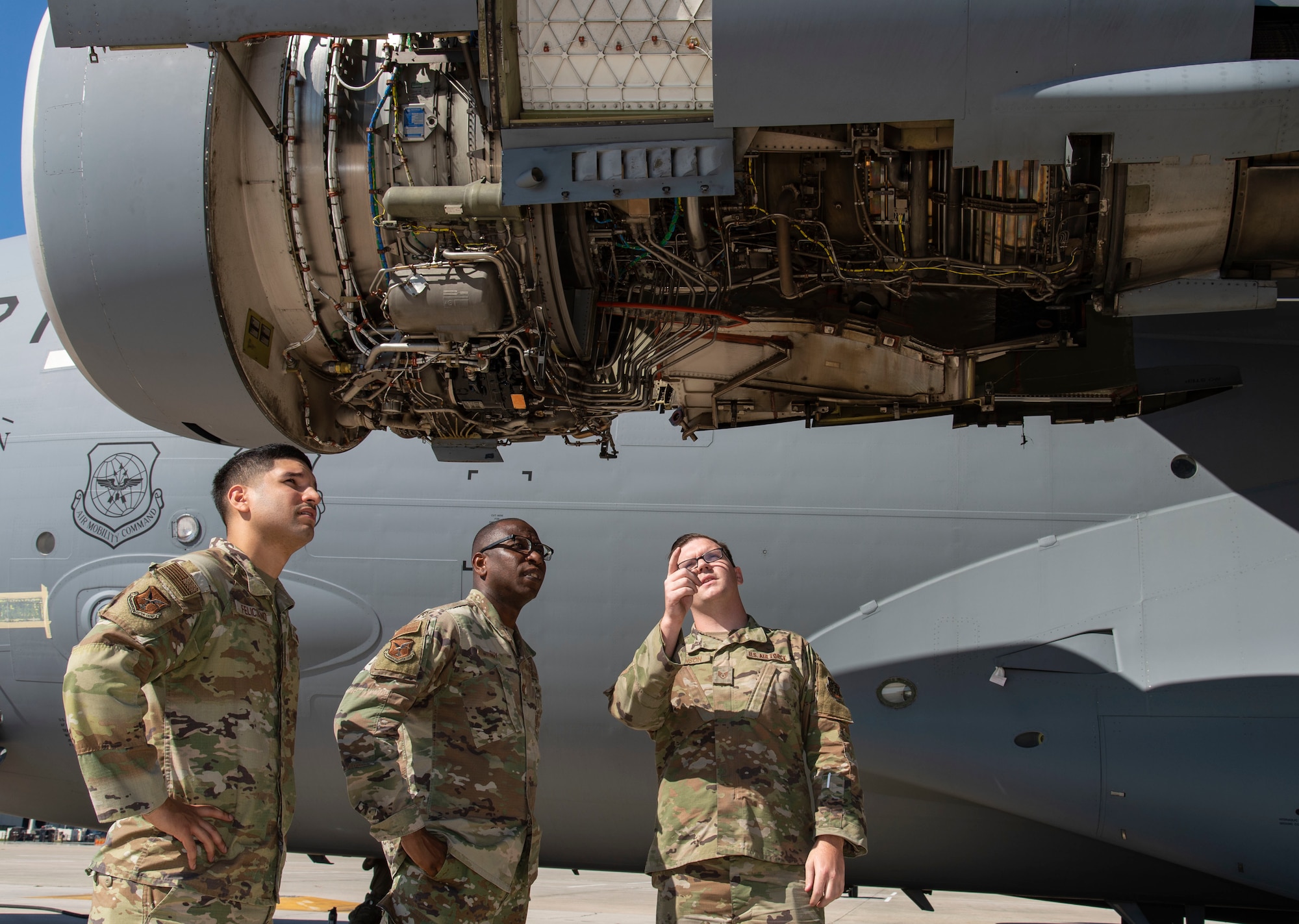 Staff Sgt. Robert Johnson, right, 736th Aircraft Maintenance Squadron C-17 Globemaster III crew chief, briefs Chaplain (Capt.) William Guy, center, 436th Airlift Wing chaplain and Tech. Sgt. Eric Feliciano, left, 512th AW religious affairs airman, on engine inspection areas during a 180-day home station check inspection being performed at Dover Air Force Base, Delaware, Oct. 11, 2022. During the Friends on the Flight Line visit, the Holy Roller van delivered drinks, sandwiches and snacks provided by the United Service Organizations, to aircraft maintainers in various squadrons under the 436th Mission Generation Group. (U.S. Air Force photo by Roland Balik)
