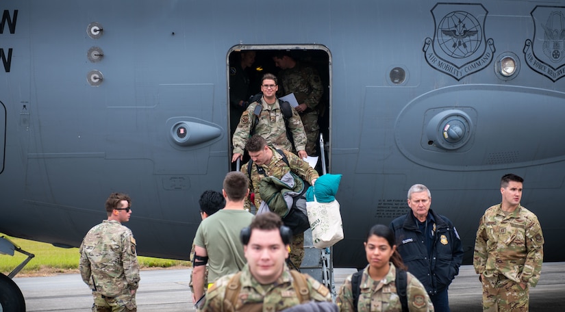 Airmen exit a C-17 Globemaster III